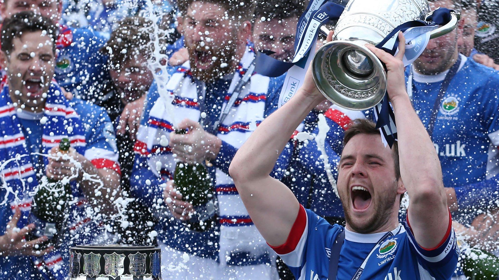 Linfield captain Jamie Mulgrew celebrates with the Gibson Cup