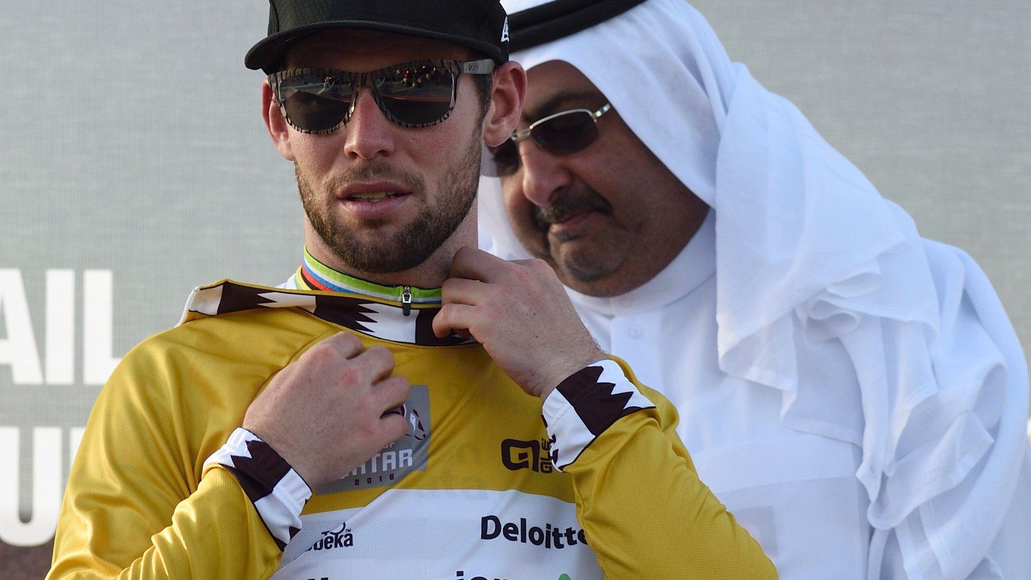 Mark Cavendish is presented with the race leader's jersey