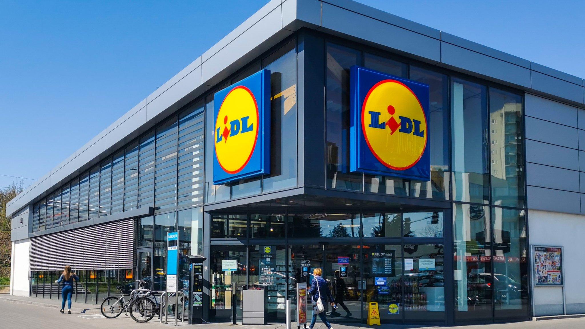 Large Lidl store with bikes outside and customers walking in