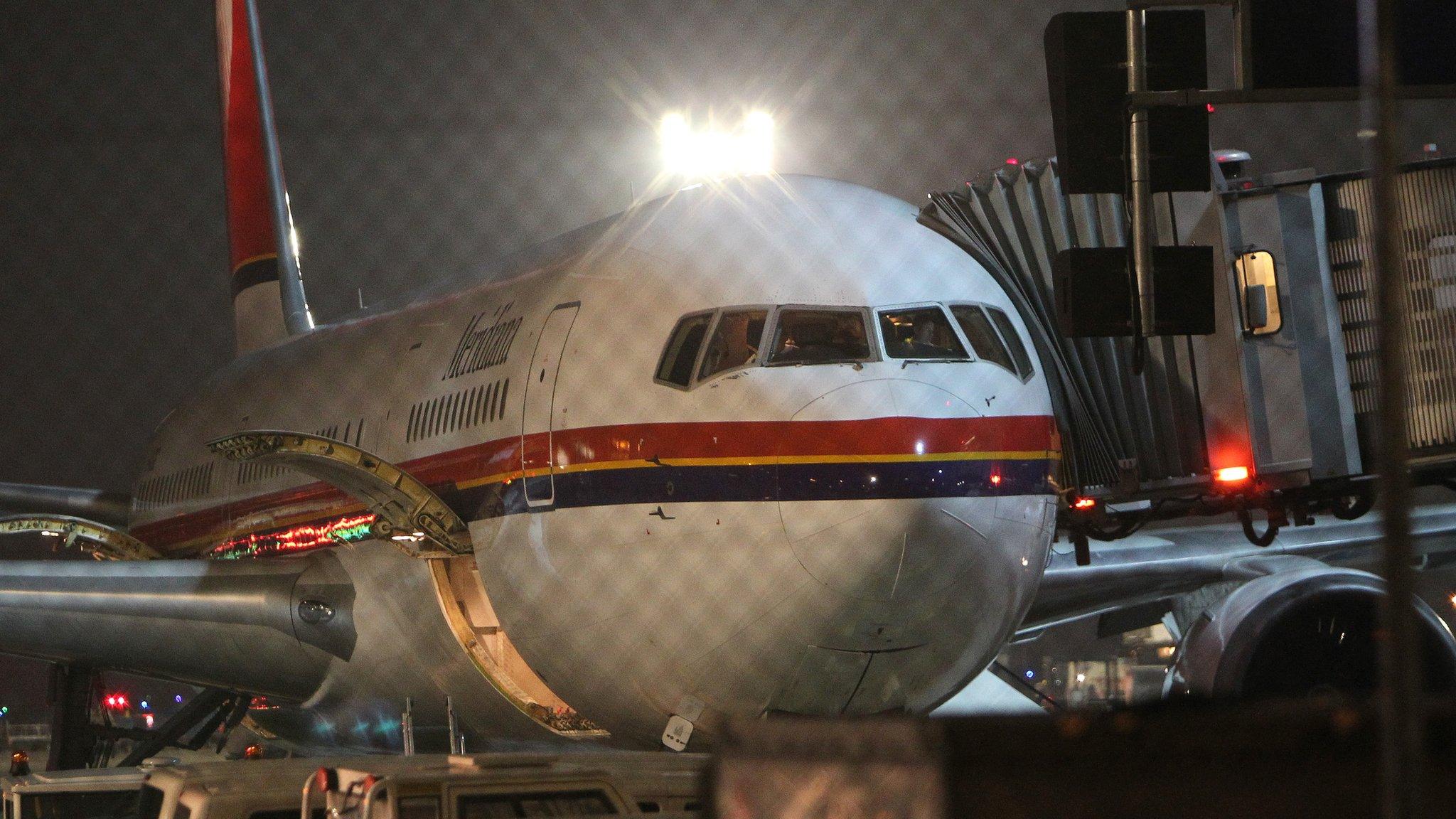 An airplane of Meridiana airline, chartered to deport refugees back to Afghanistan waits to take off at the airport in Frankfurt am Main, western Germany on December 14, 2016