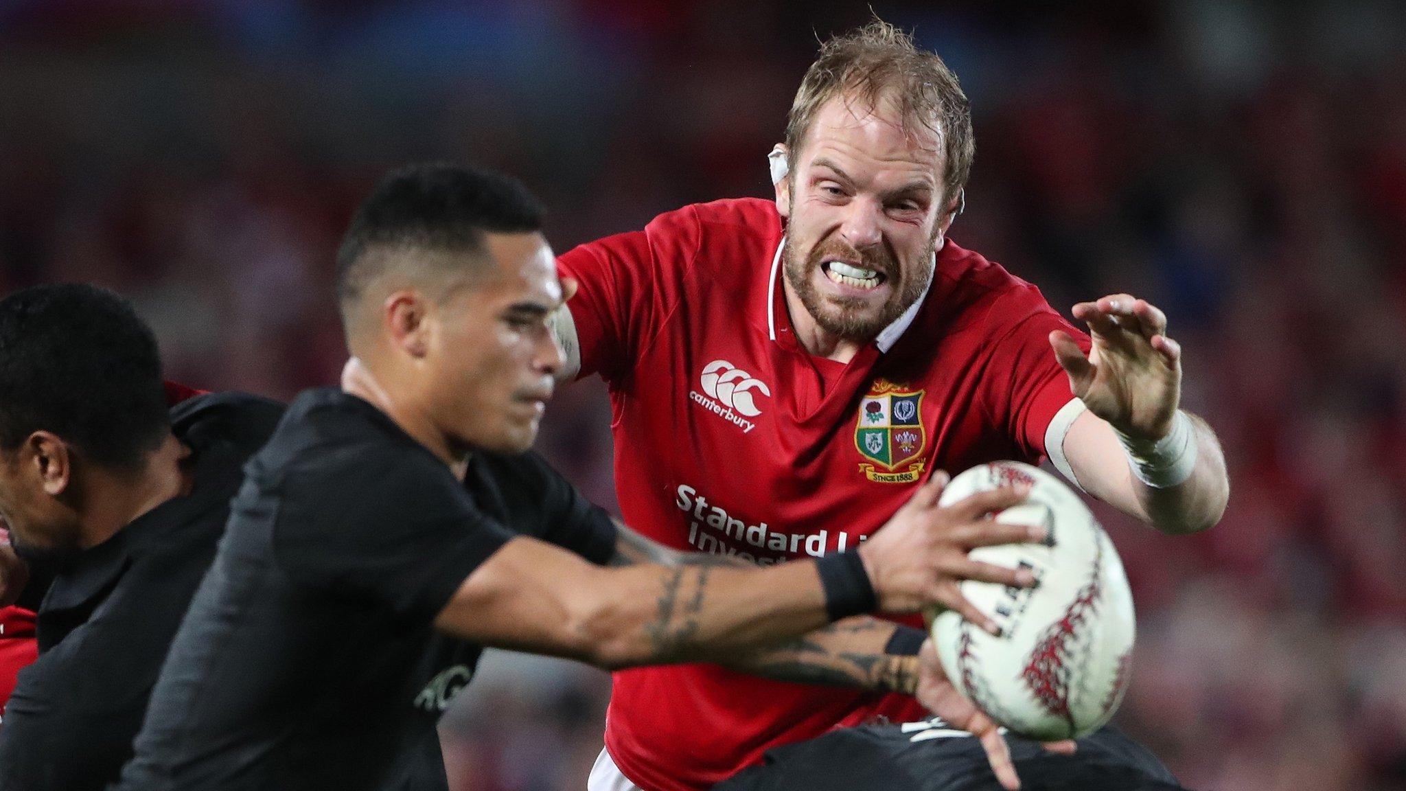 Lions lock Alun Wyn Jones tries to charge down New Zealand scrum-half Aaron Smith