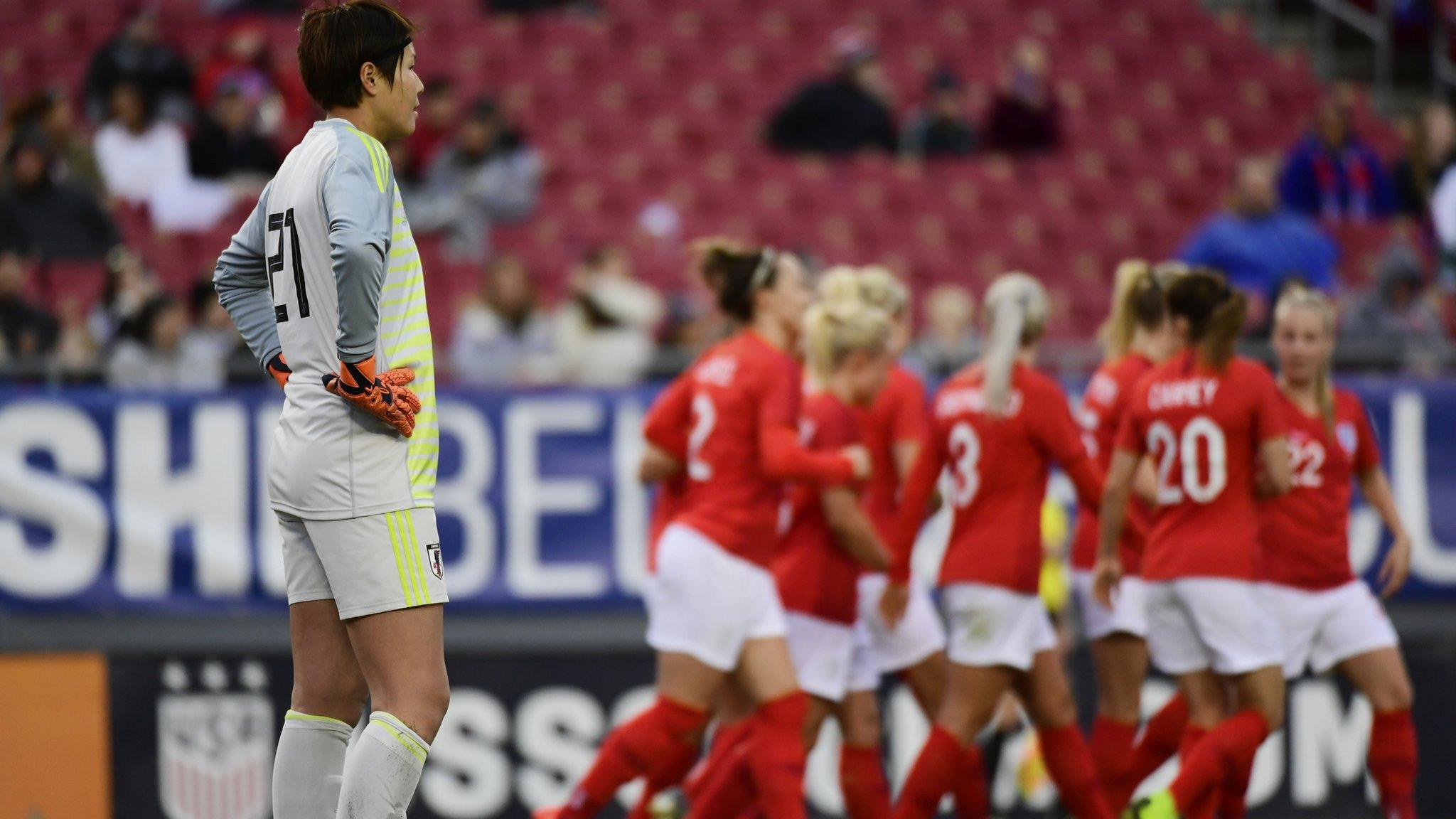 Erina Yamane of Japan stands in front of the celebration for Karen Carney of England's goal during the first half during the She Believes Cup final
