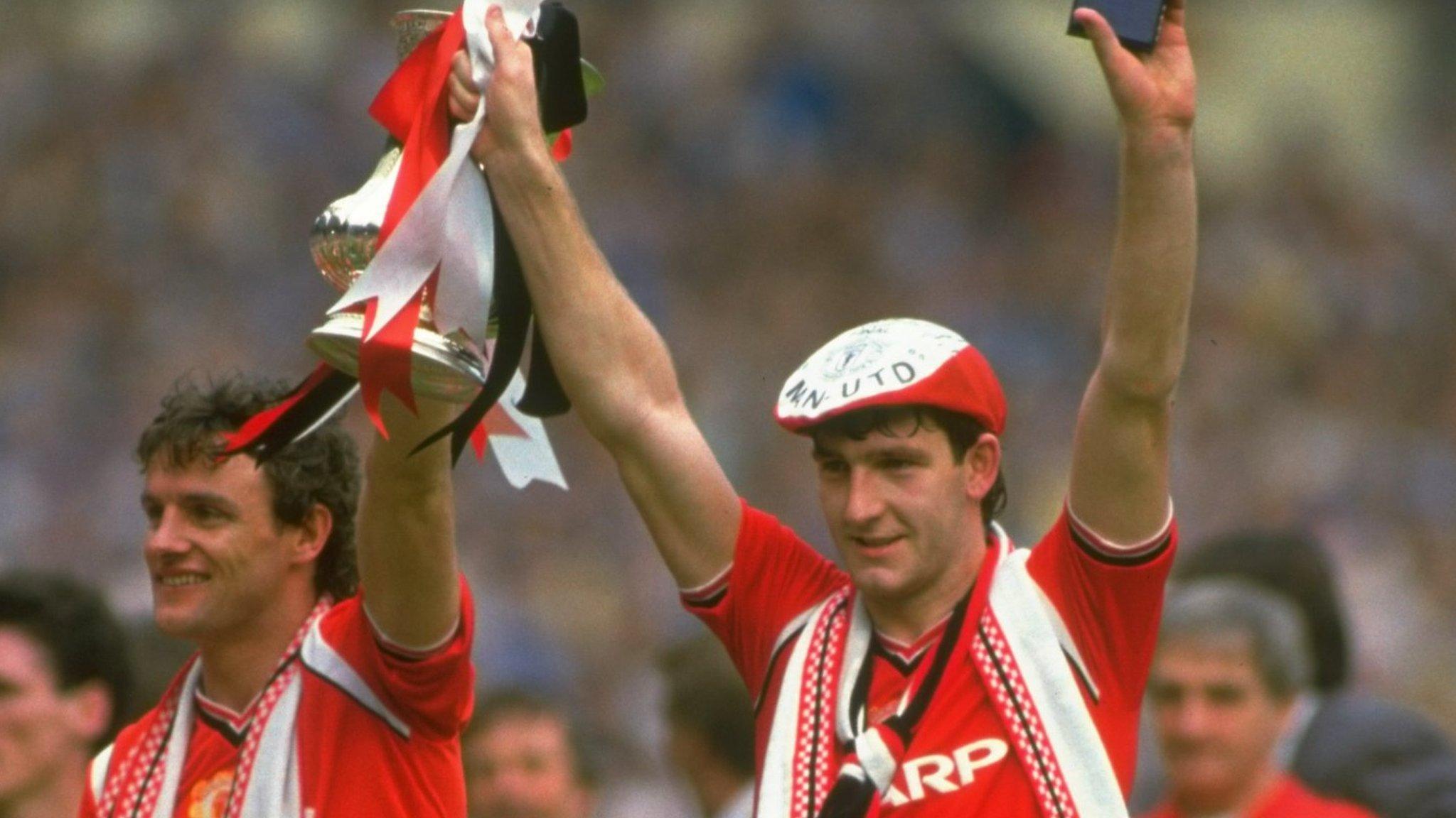 Norman Whiteside hold the FA Cup aloft after the 1985 final