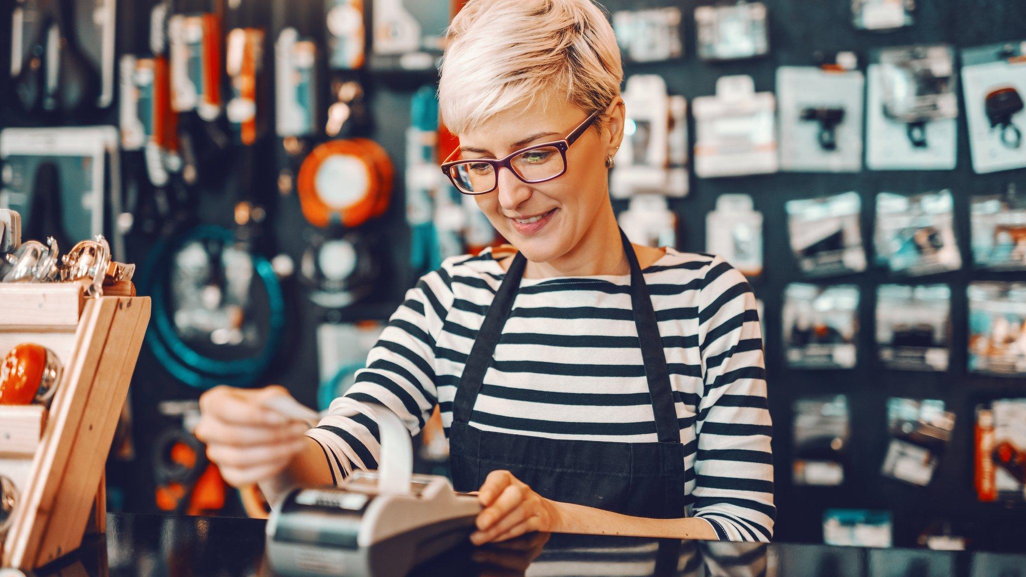 Woman taking a payment in a shop