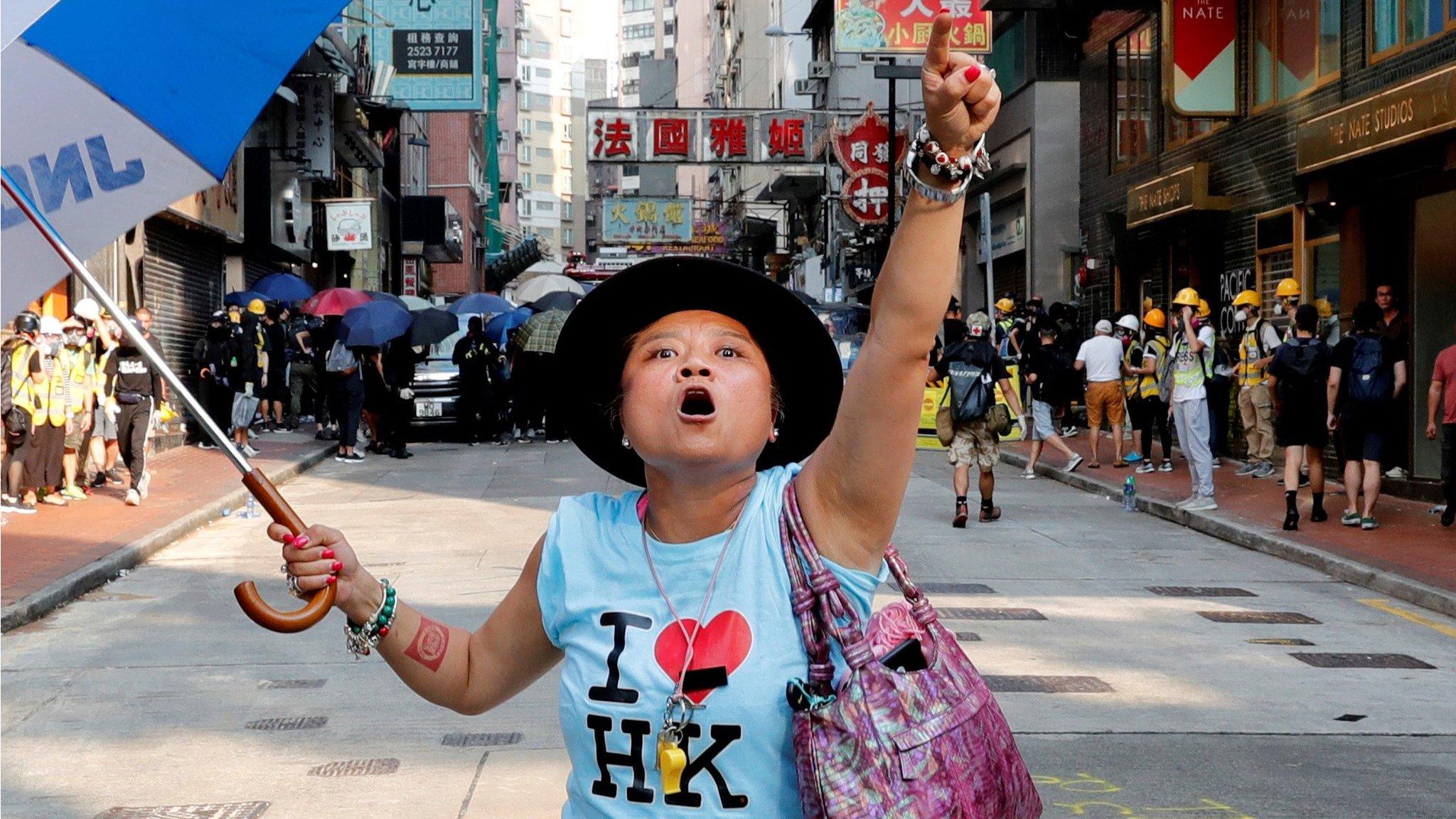 An anti-government demonstrator shouts toward Tsim Sha Tsui Police Station during a protest in Hong Kong, China, October 20, 2019