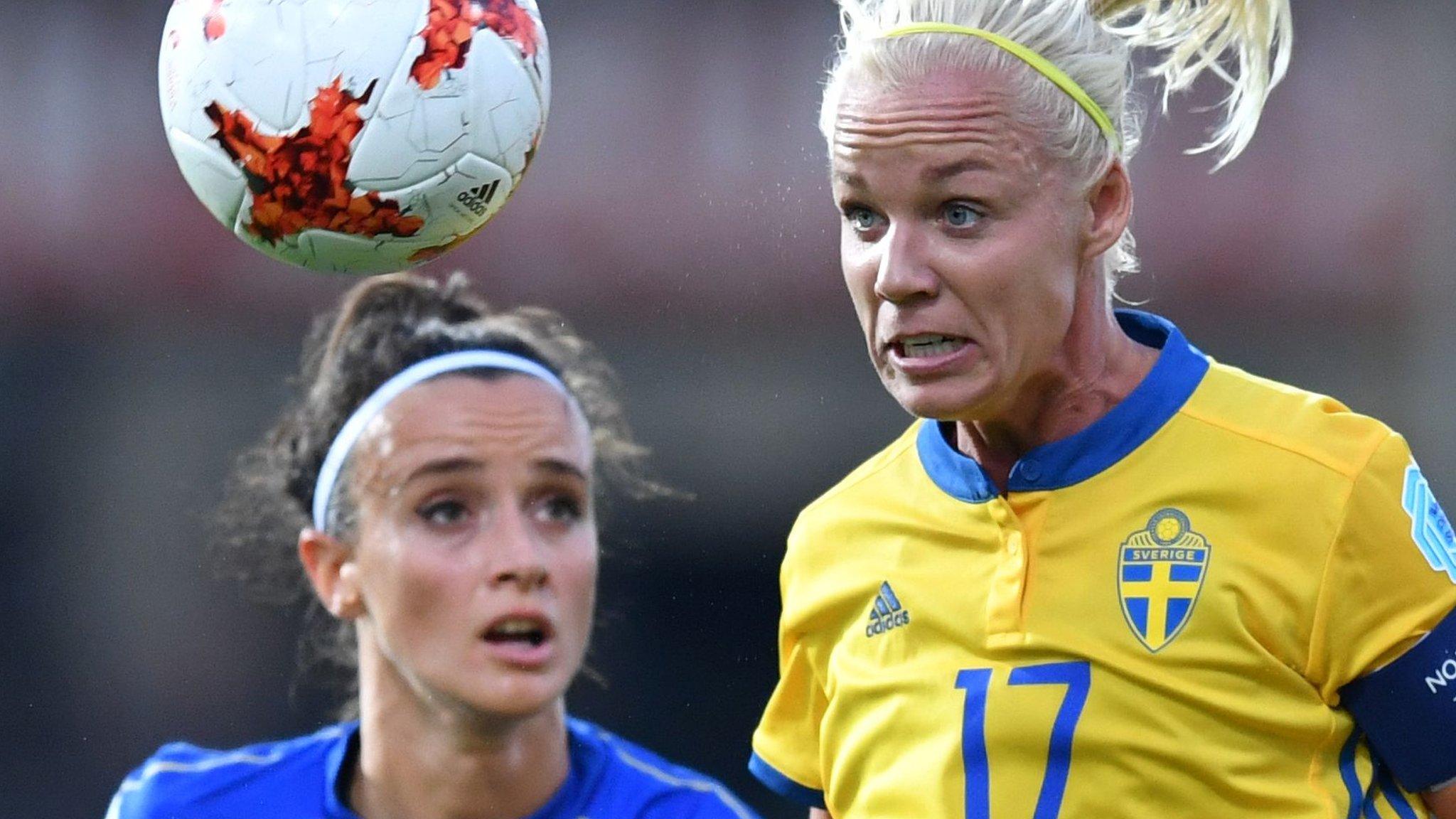 Sweden and Italy players contest a header