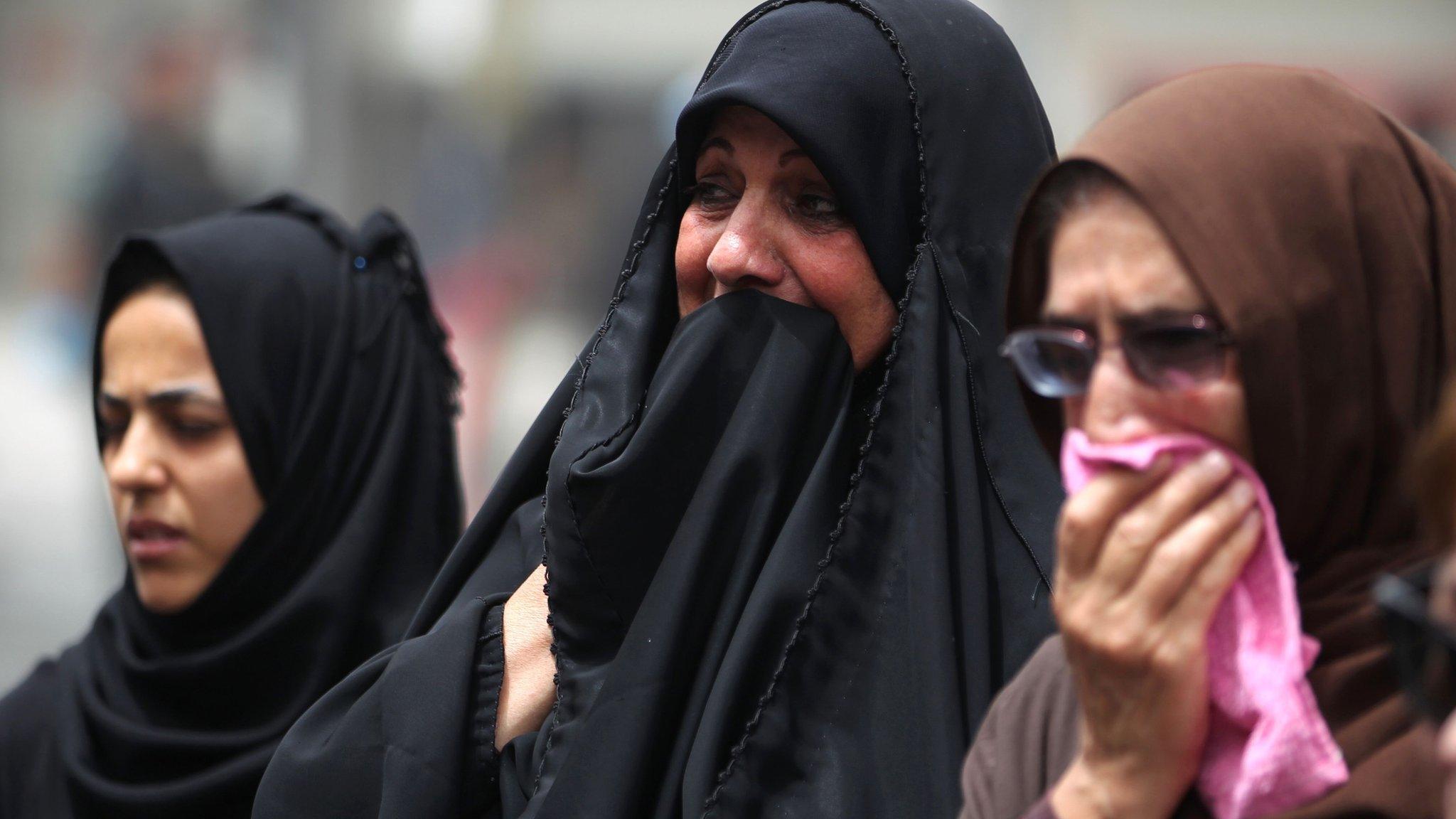 Women weep at the site of a suicide bombing in Baghdad's Karrada district (4 July 2016)