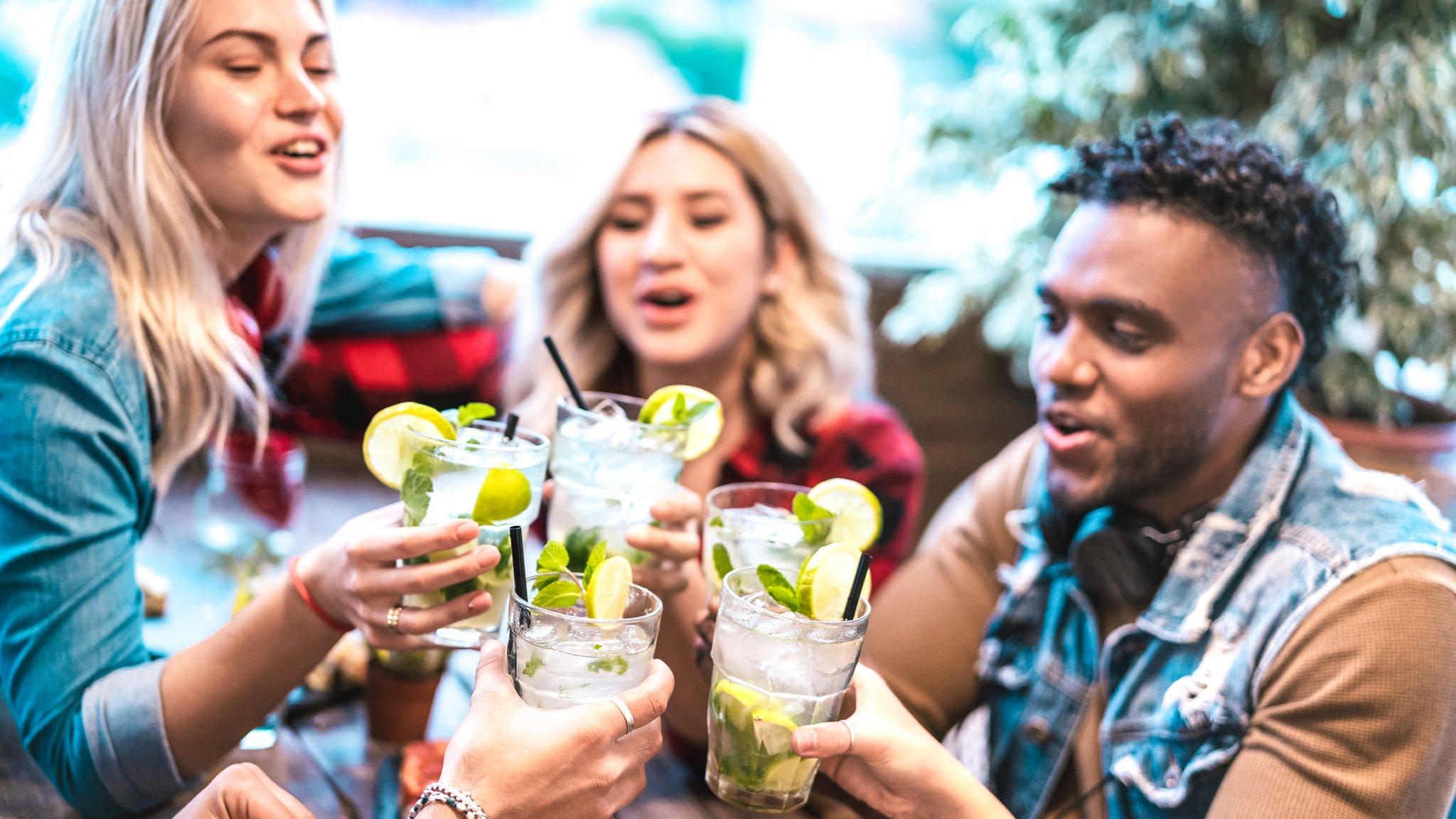 Young people drinking cocktails