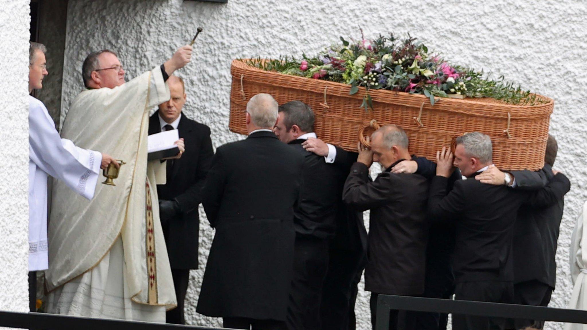 Priest Father John Joe Duffy blesses the coffin of Jessica Gallagher