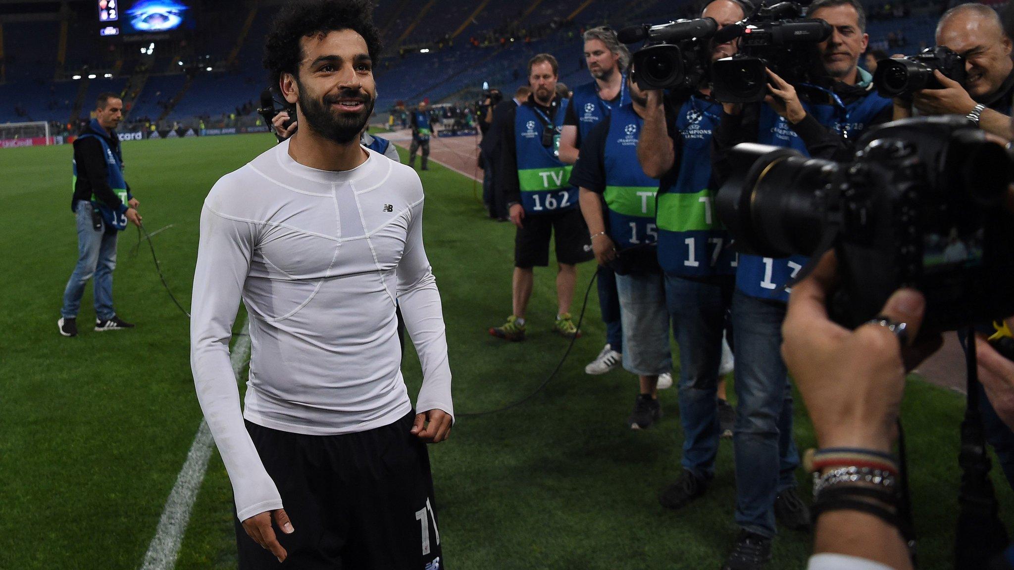 Mo Salah is surrounded by photographers