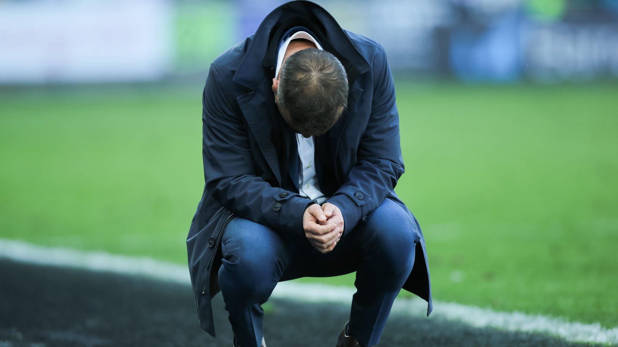 Carlos Carvalhal crouches down looking utterly dejected