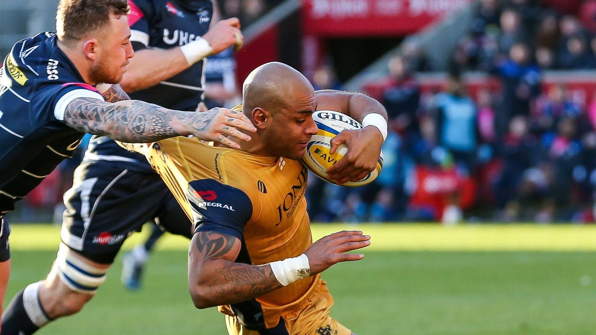 Josh Charnley of Sale Sharks attempt the tackle as Tom Varndell of Bristol