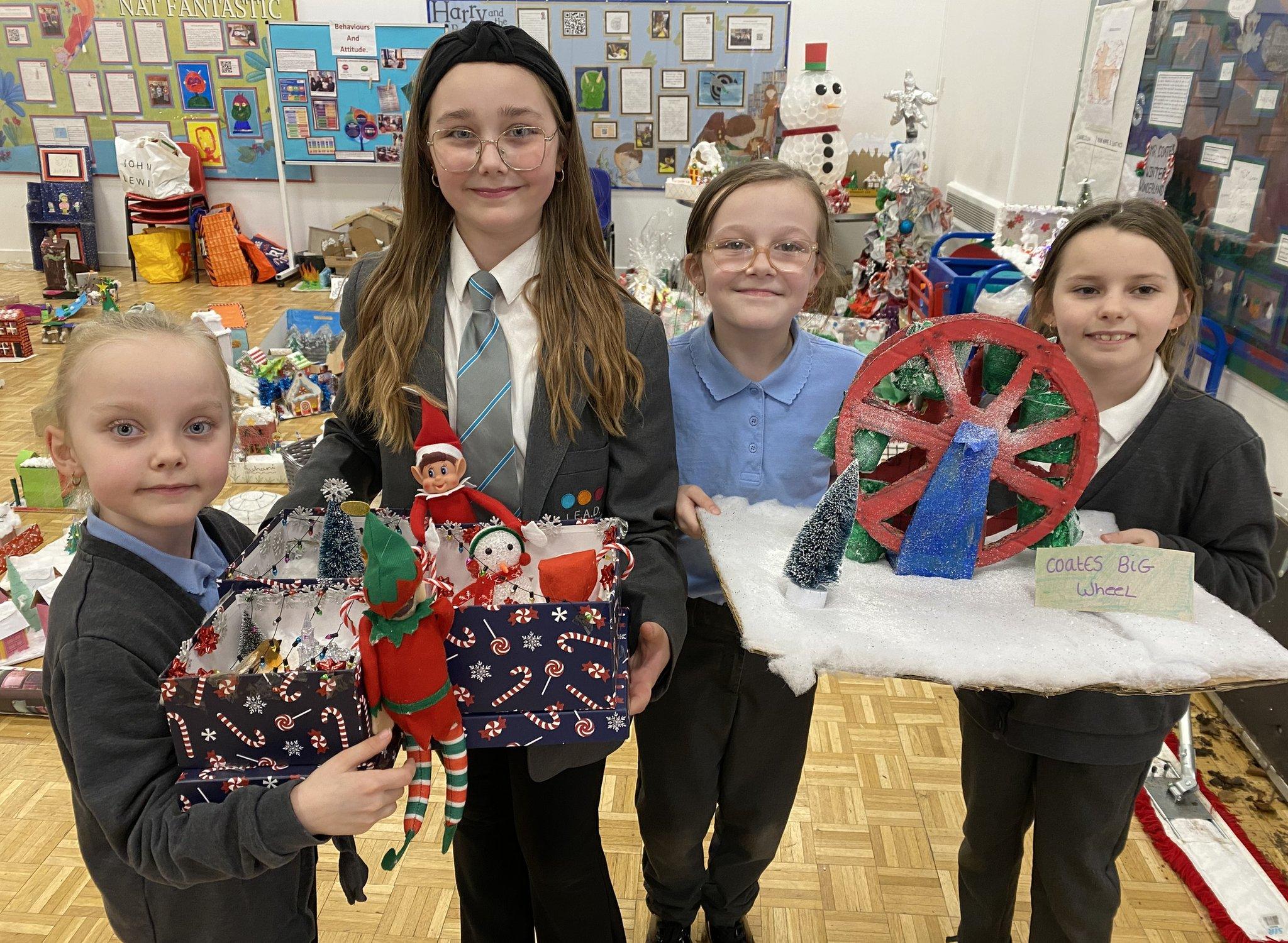 School pupils holding their Christmas creations