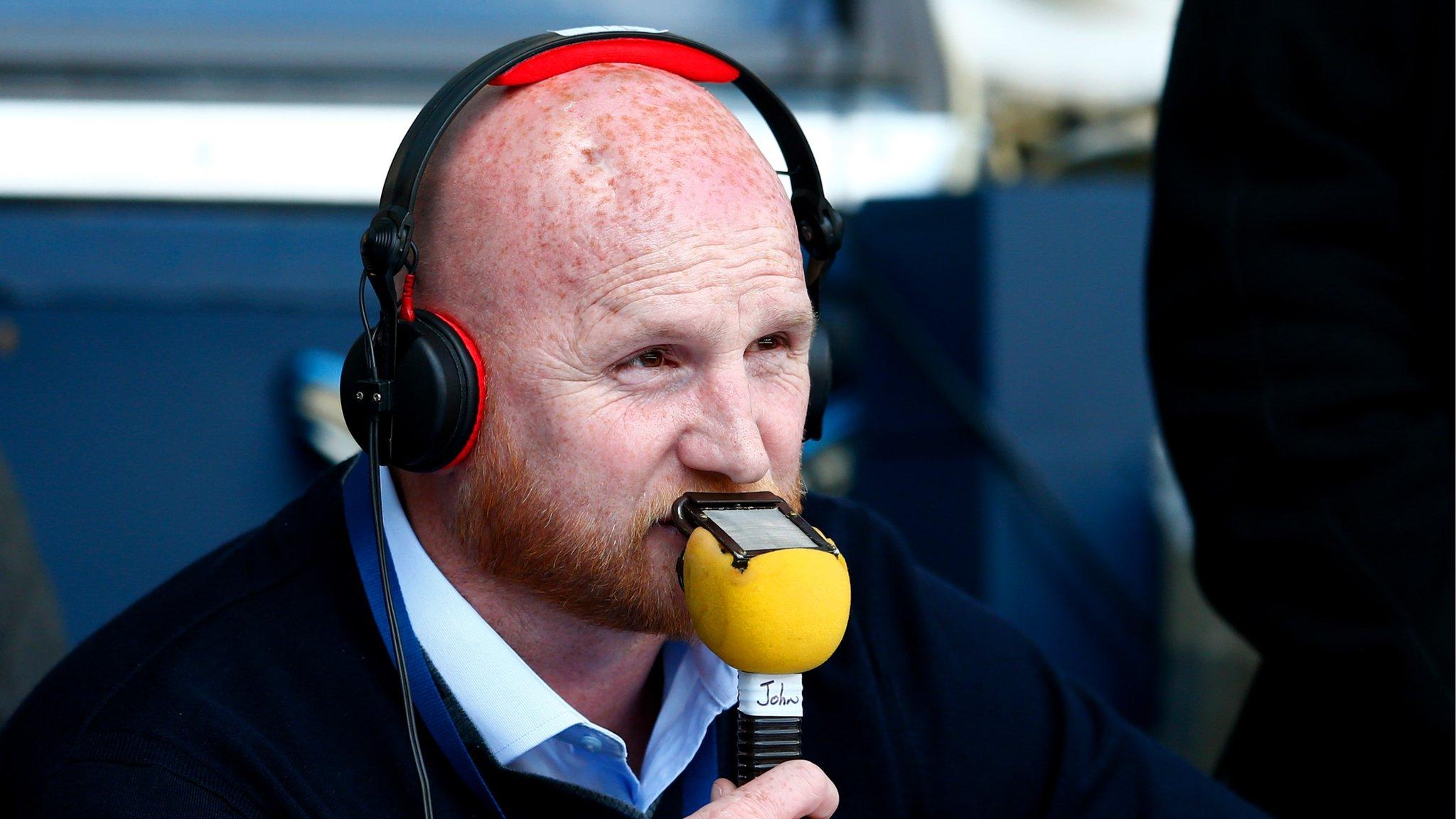 John Hartson commentates at a football match