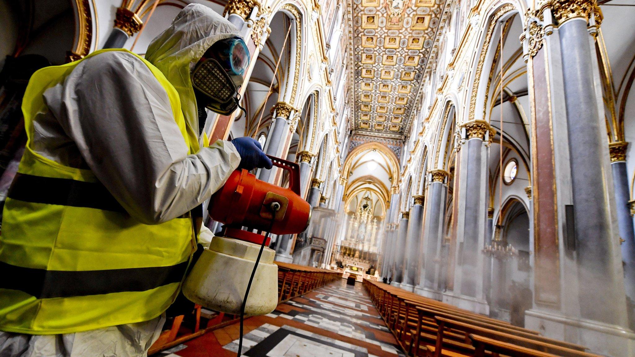 A person fumigates a church in Naples, Italy, 06 March 2020