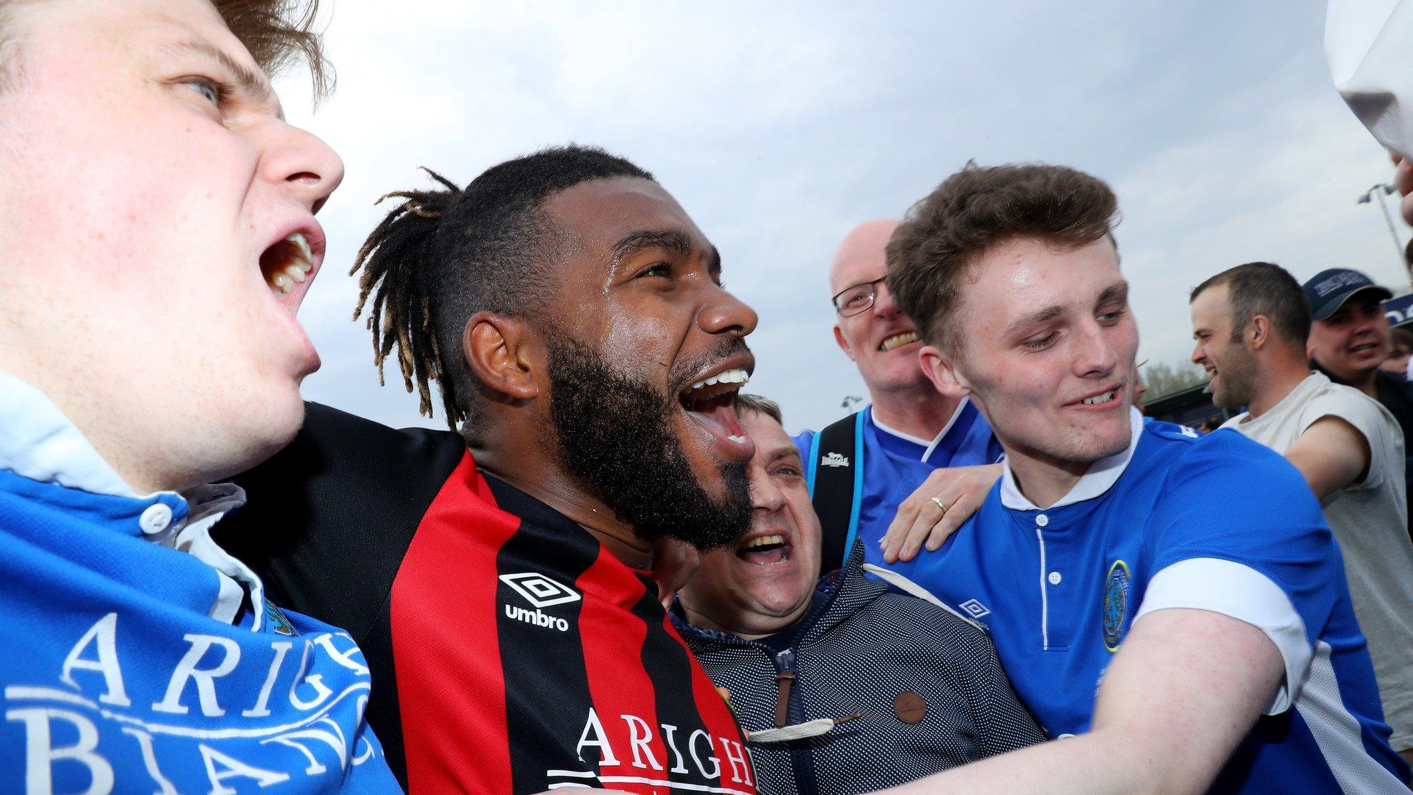 Macclesfield Town's Tyrone Marsh celebrates with their fans after the final whistle