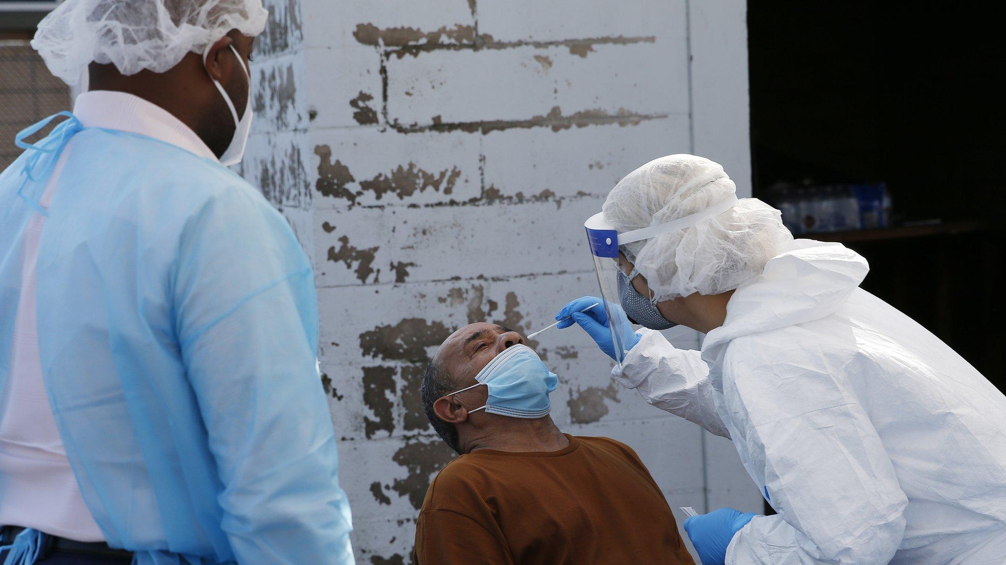 A nurse a coronavirus test at a COVID-19 testing site in Boston on Oct. 22, 2020.