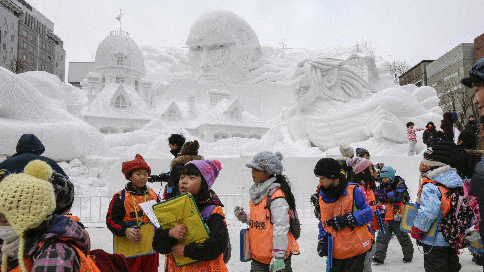 Children looking at the sculptures of the 67th Sapporo Snow Festival