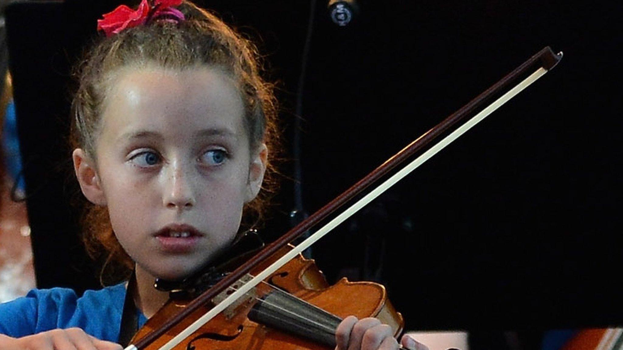 Children from the Raploch estate Big Noise orchestra play at The Big Concert on 21 June 2012 in Stirling, Scotland