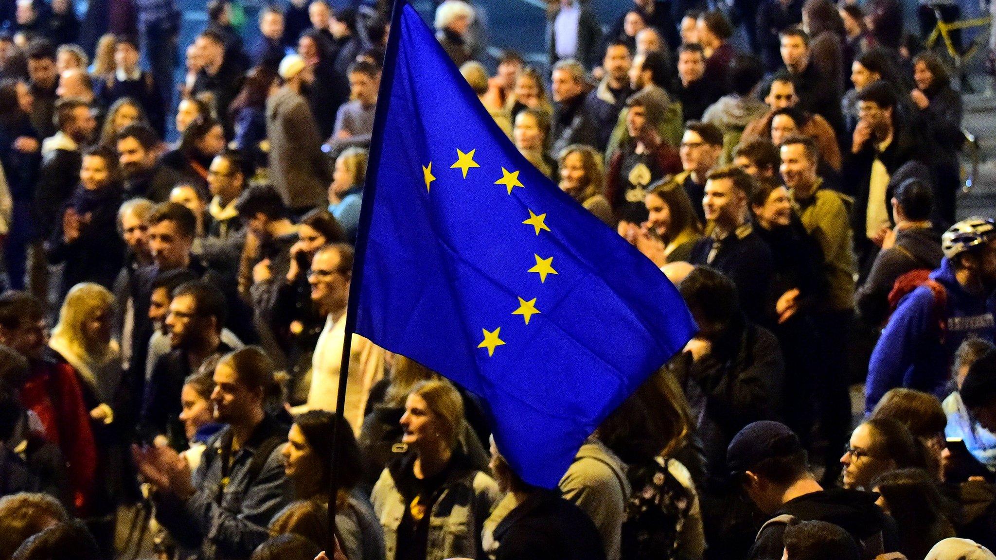 People march holding an EU flag at Heroes Square in a protest against legislation which students and teachers fear will see the Central European University shut down, in downtown Budapest on 9 April 2017