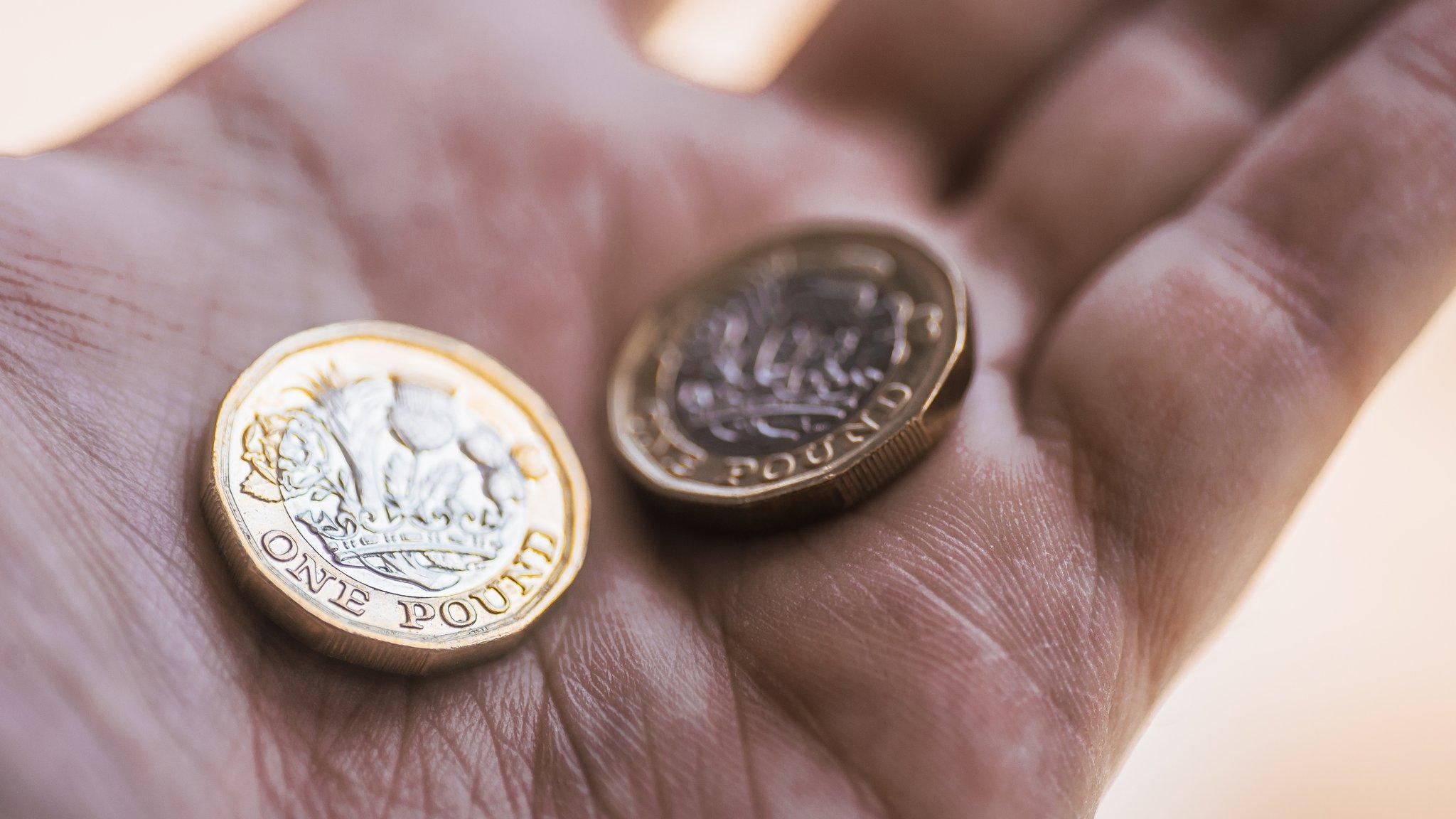 two pound coins in the hand