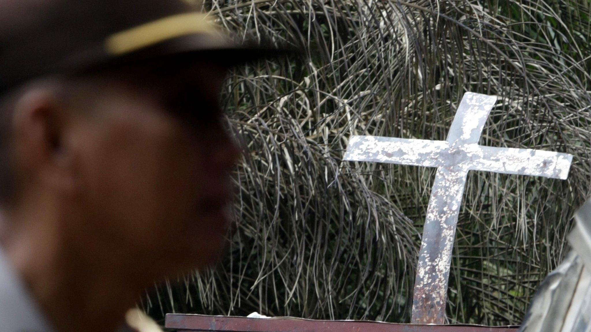 Security forces inspect the scene of a burned Church in Aceh Singkil, Indonesia