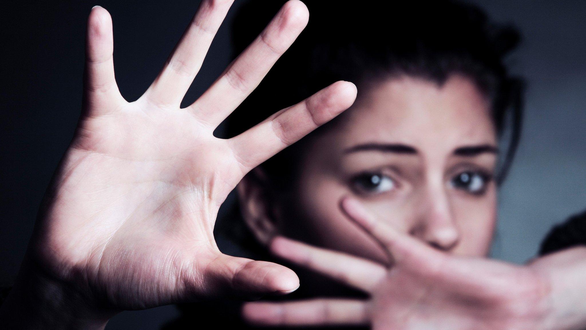 A woman with her hands up - pic posed by model