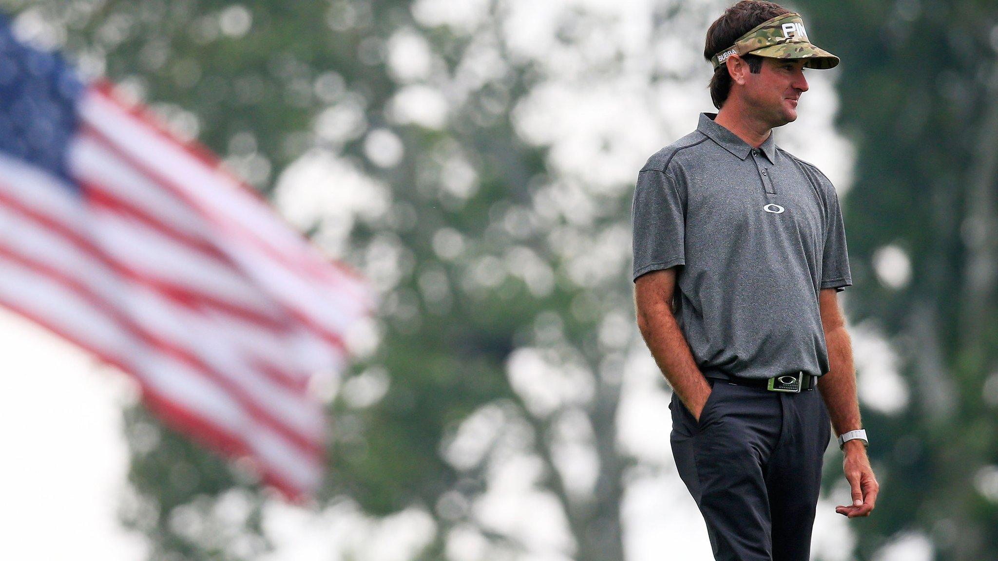 Bubba Watson stands in front of an American flag at the US Open