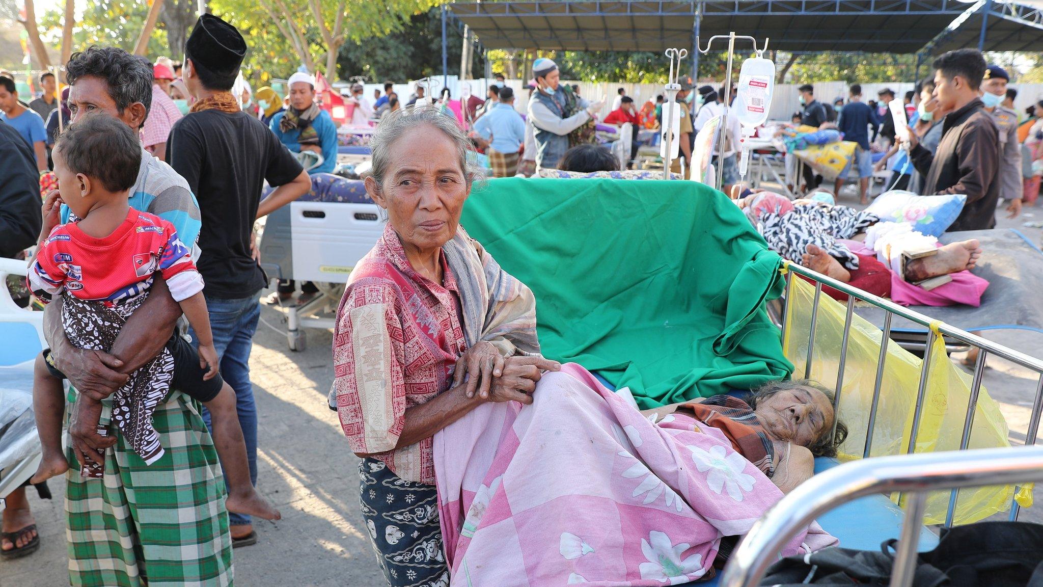 Hospital patients in their beds are moved to an emergency tent outside of Tanjung hospital after an earthquake struck northern Lombok, Indonesia, 6 August 2018