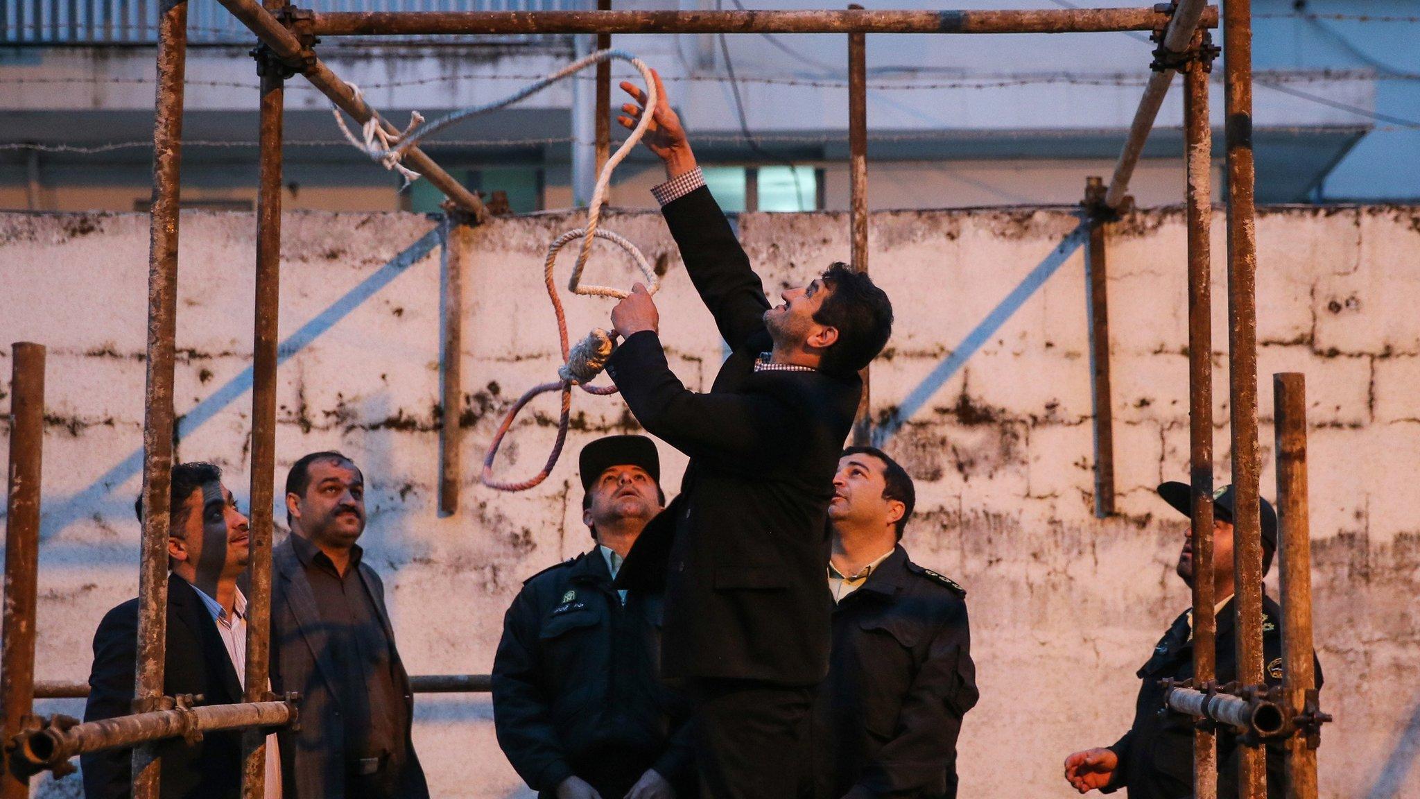 Iranian officials prepare a noose for an execution in Noor of a convicted murderer who was eventually spared by the mother of his victim (15 April 2014)