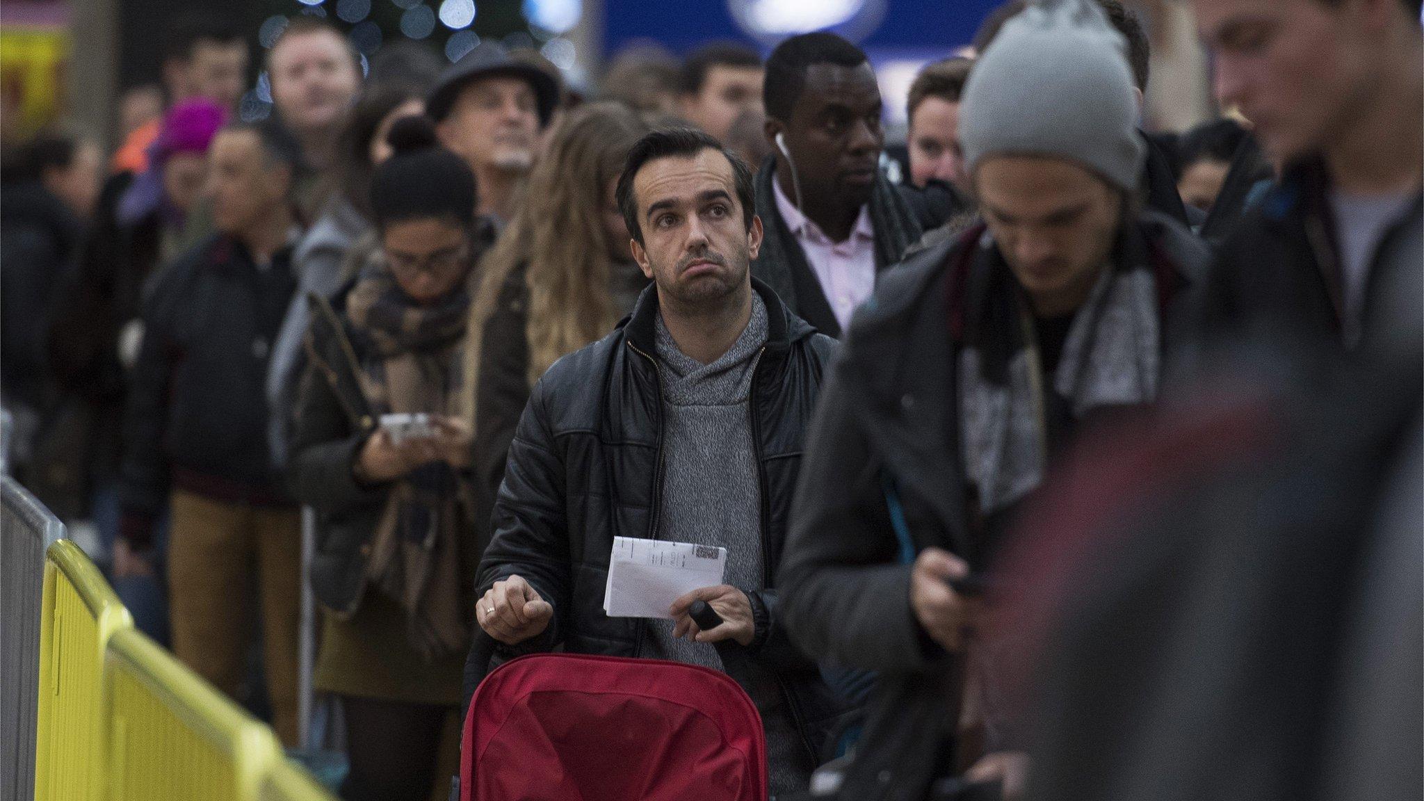 Commuters wait for a delayed service during an earlier strike