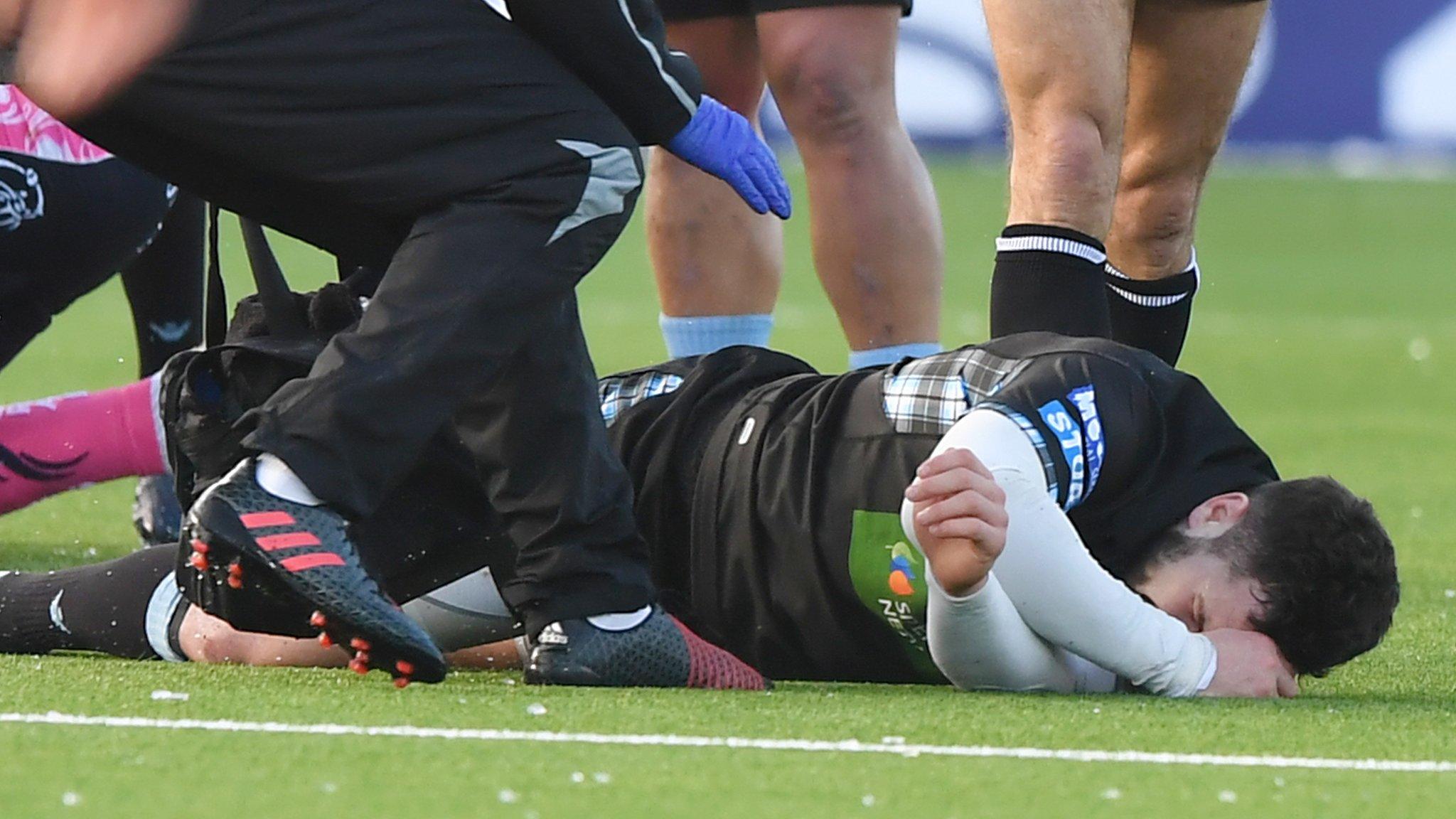 Alex Dunbar writhes in agony after suffering a leg injury