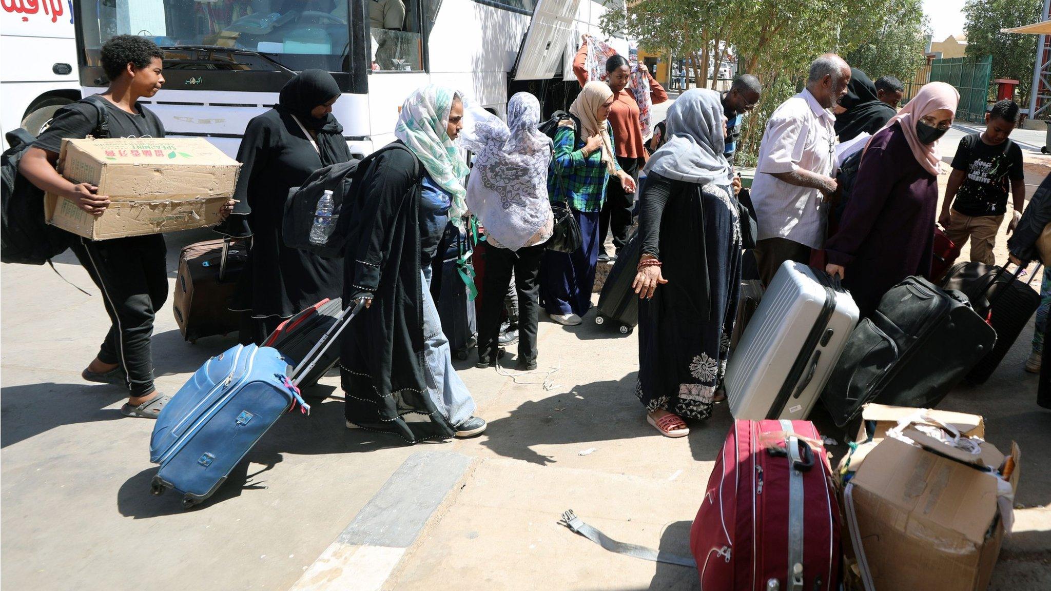 People fleeing Sudan arrive at the Qastal Land Port after crossing the border from Sudan