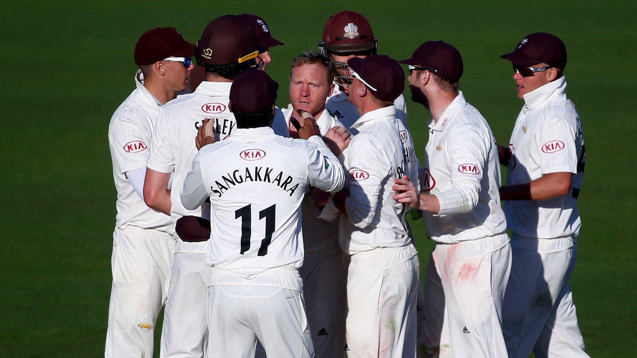 Surrey players celebrate the fall of another Bears wicket at The Oval