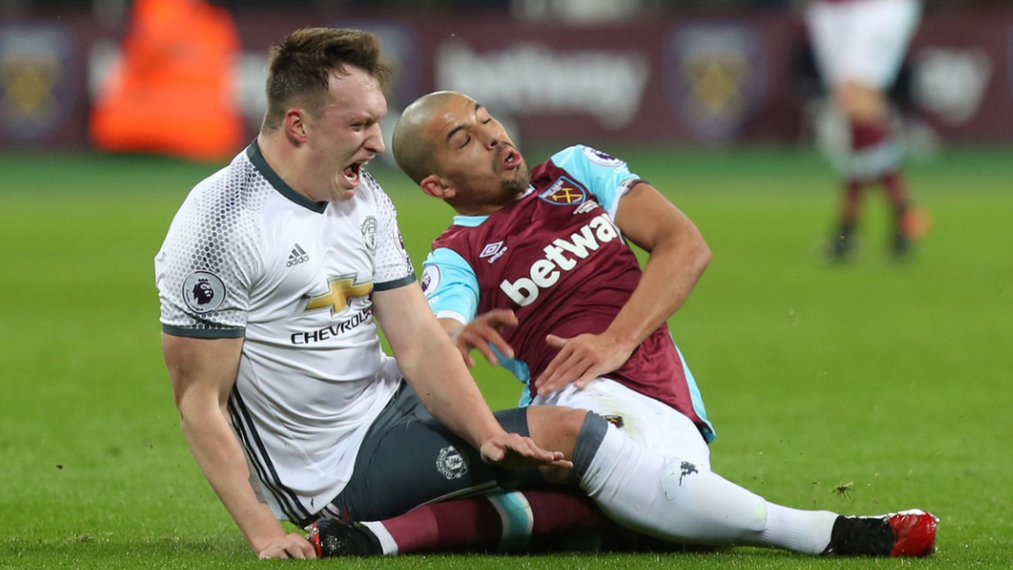 Phil Jones and Sofiane Feghouli hallenge for the ball which results in a red card for the West Ham player