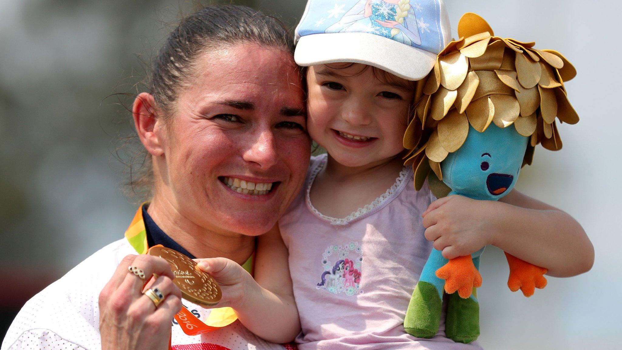 Great Britain"s Sarah Storey celebrates with her daughter Louisa after winning gold in the Women"s road race C4-5 during the 10th day of the 2016 Rio Paralympic Games in Rio