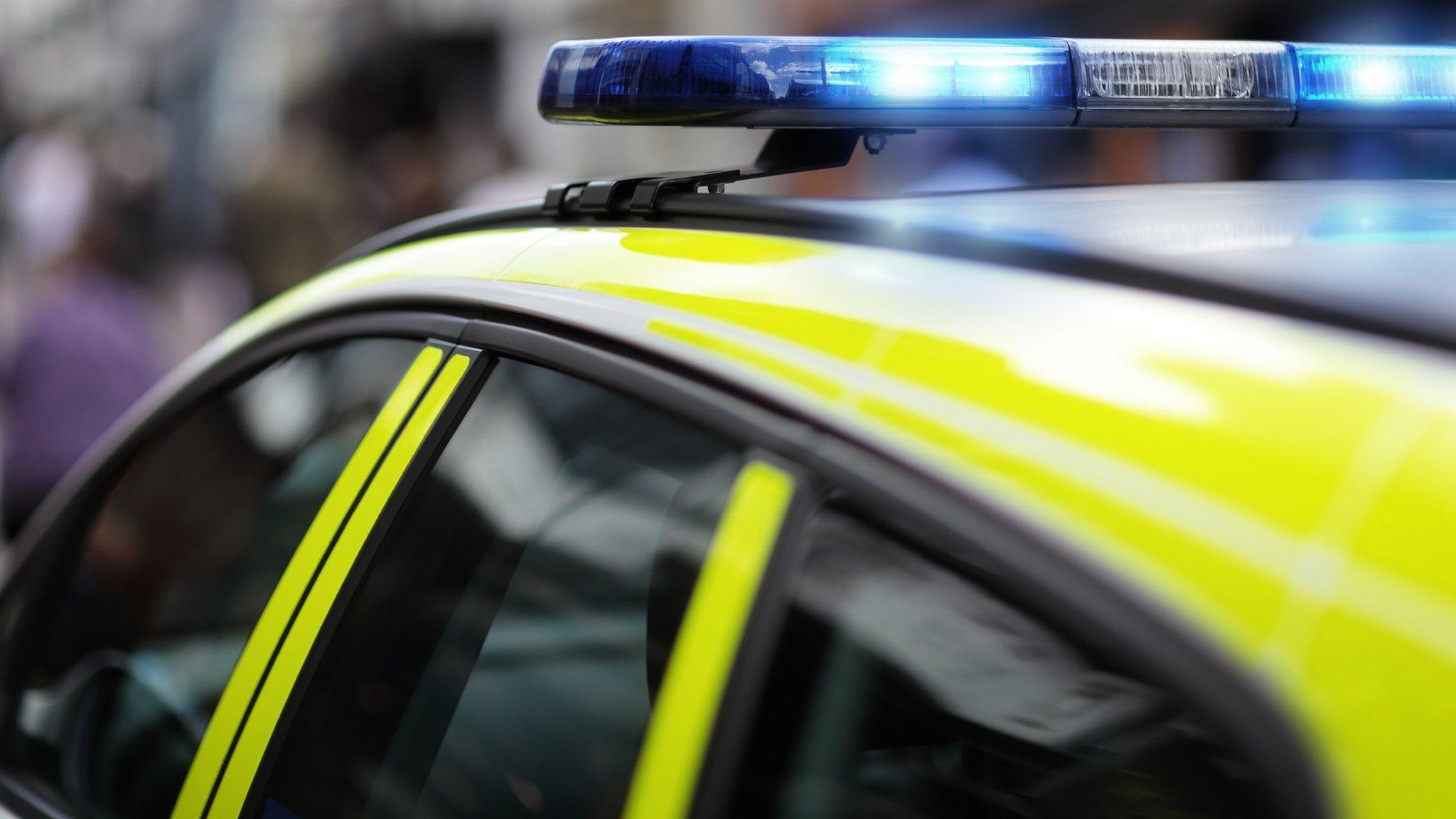 A police car with blue lights flashing