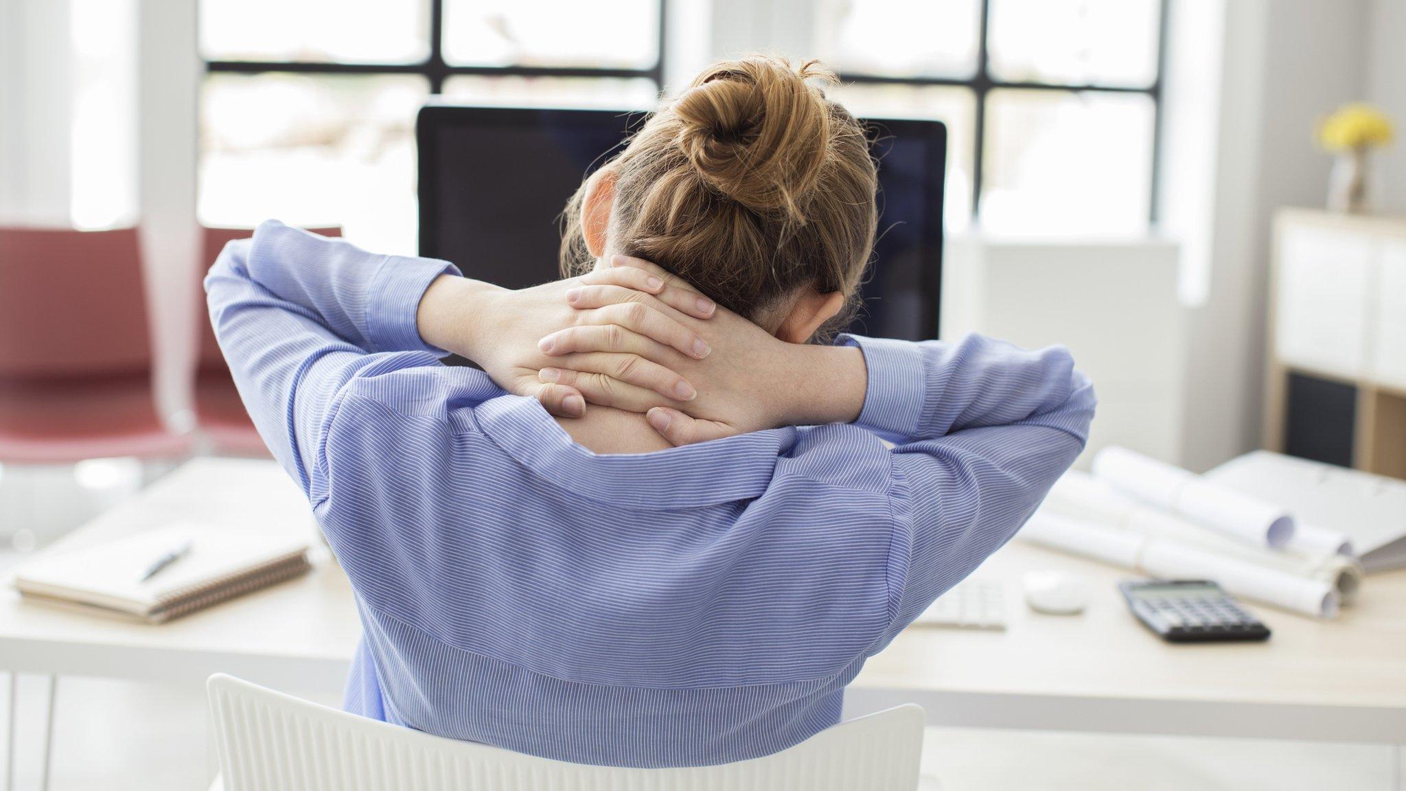 Back of woman's head at desk