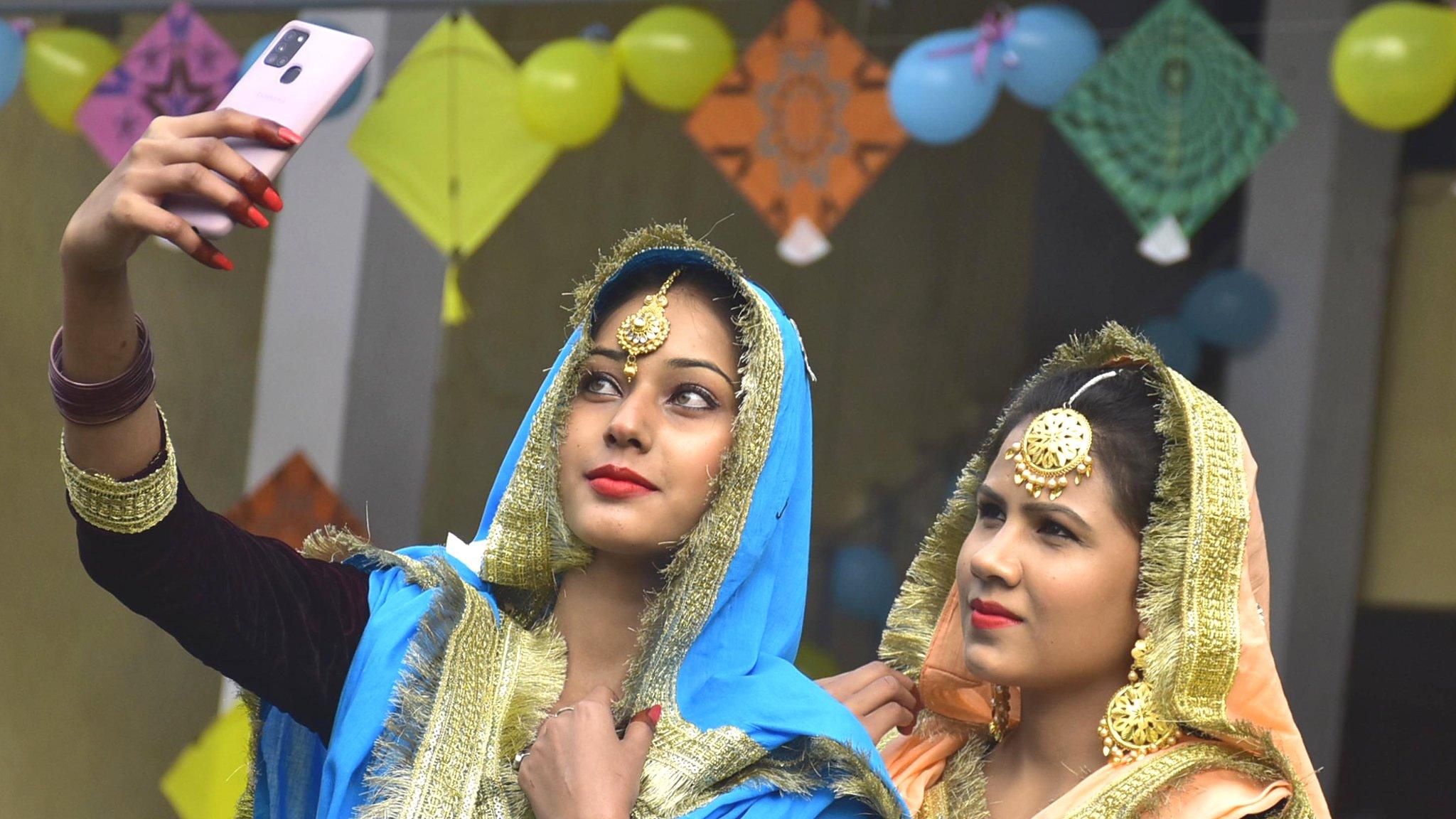 Students click a selfie amid Lohri festival celebrations at Shahzada Nand College on January 13, 2021 in Amritsar, India.