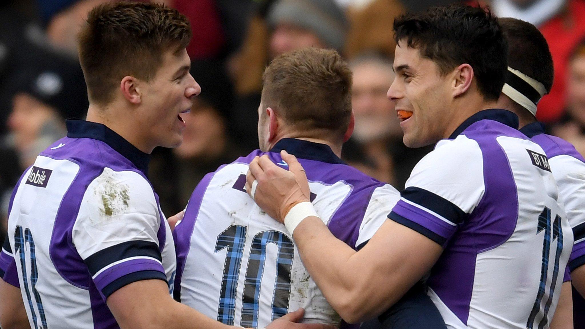 Huw Jones (left) and Finn Russell help Sean Maitland (right) celebrate scoring a try for Scotland