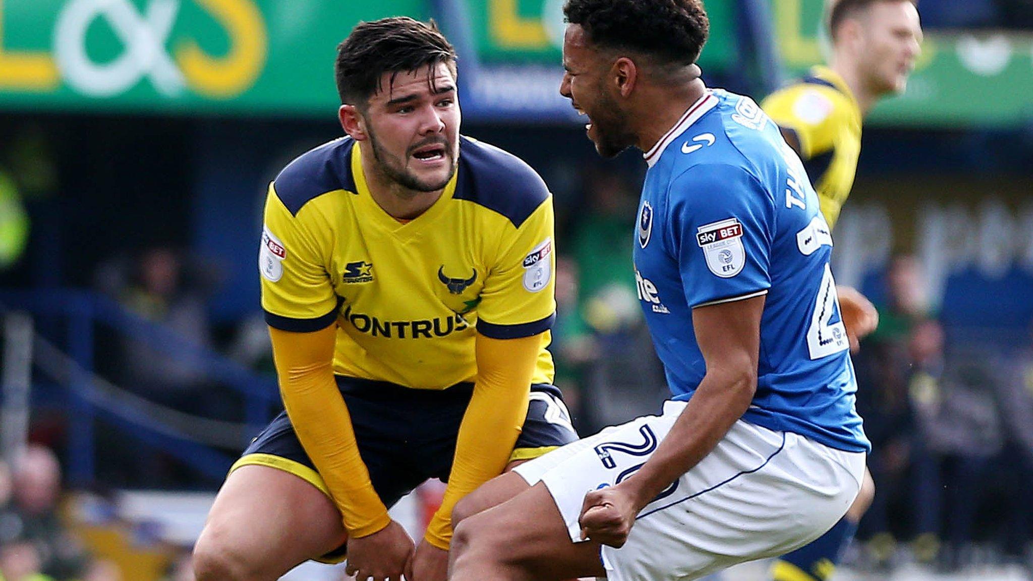 Alex Mowatt is goaded by Nathan Thompson after his penalty miss for Oxford against Portsmouth