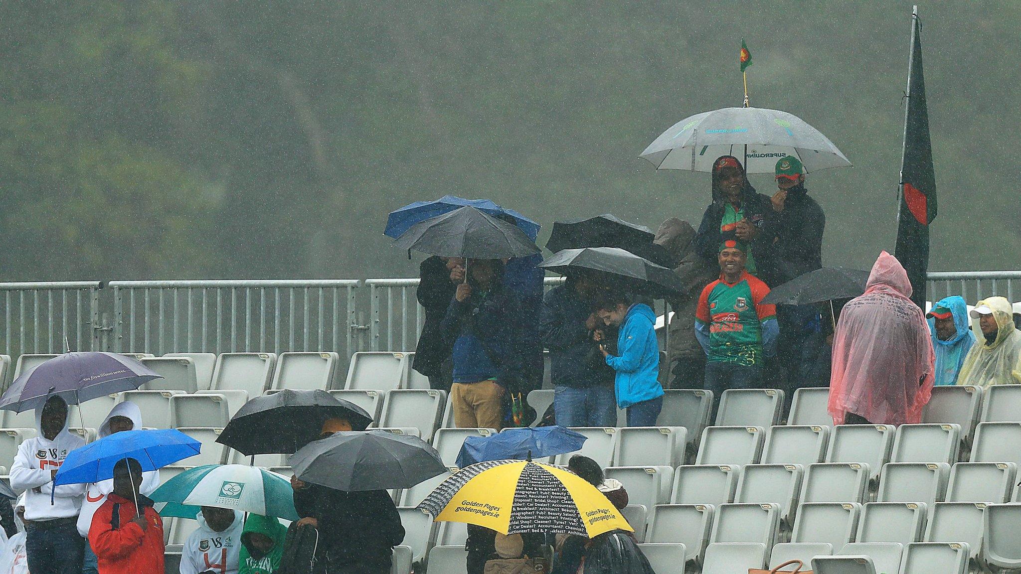 Bangladesh supporters take cover in the Malahide rain