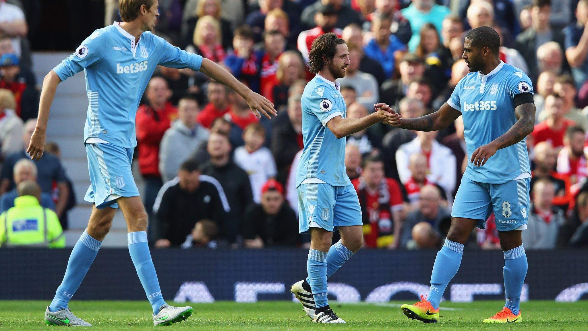 Stoke City players celebrate a goal against Manchester United