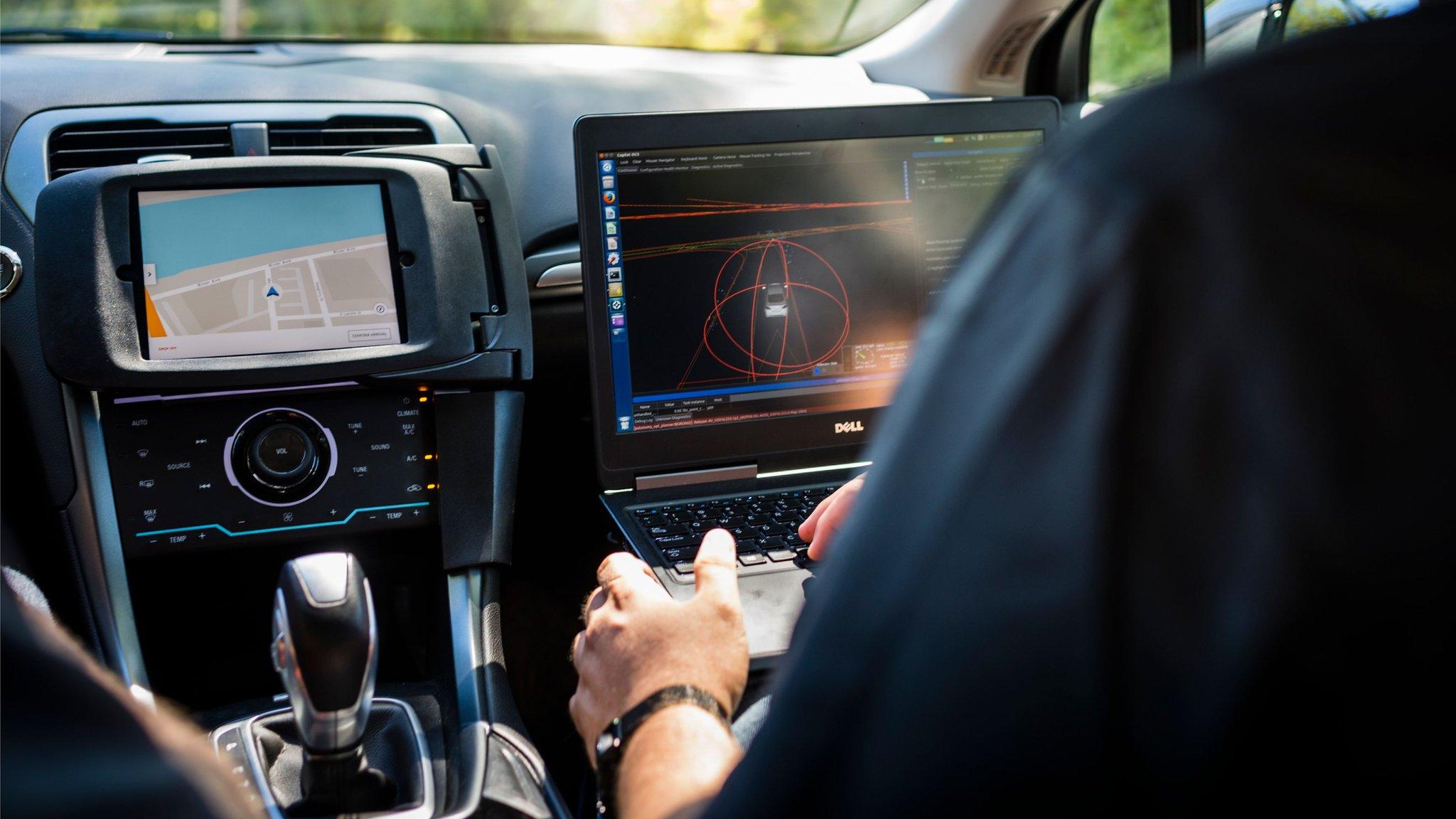 A passenger in a self-driving car.