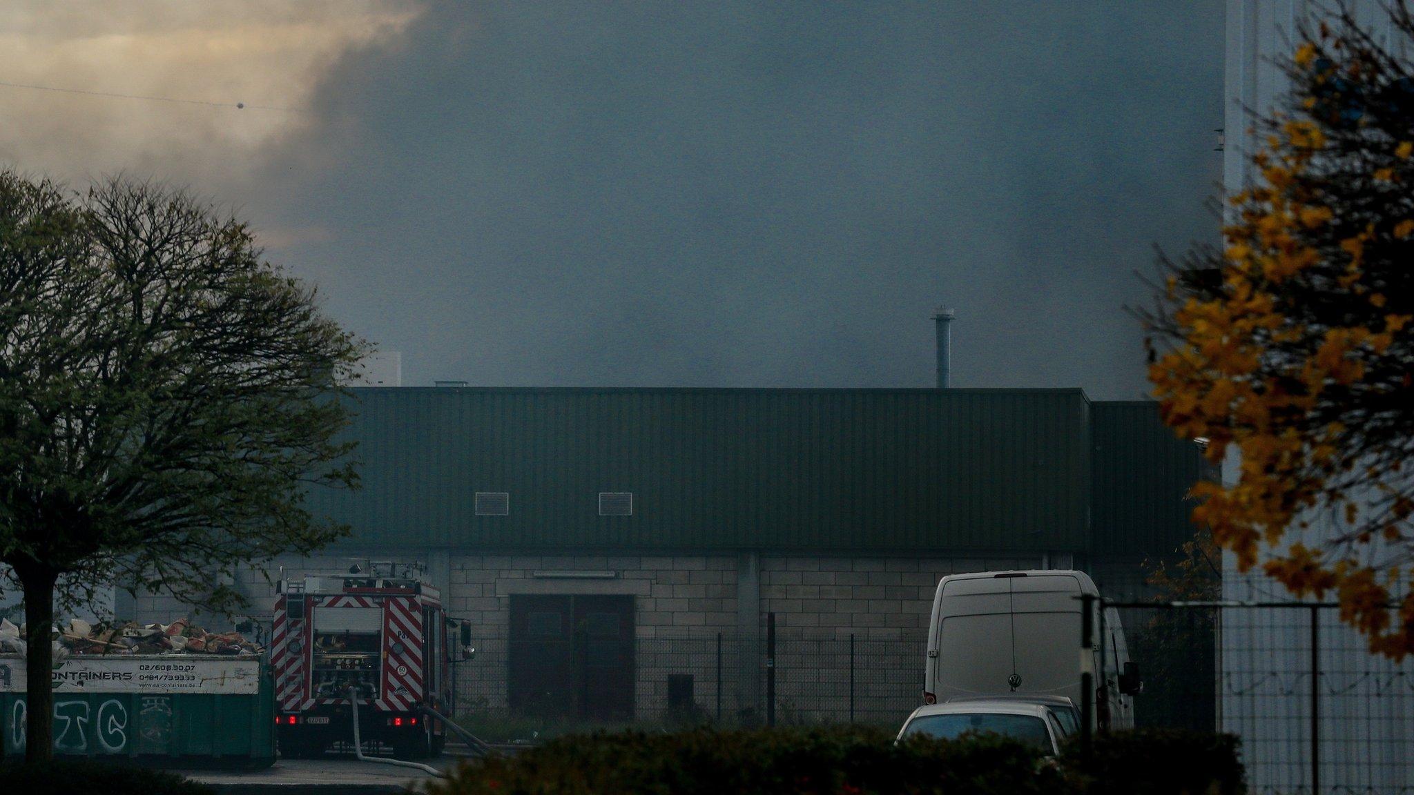 Smoke billows from the Milcamps waffle factory in Forest in Brussels, Belgium, 23 November 2017