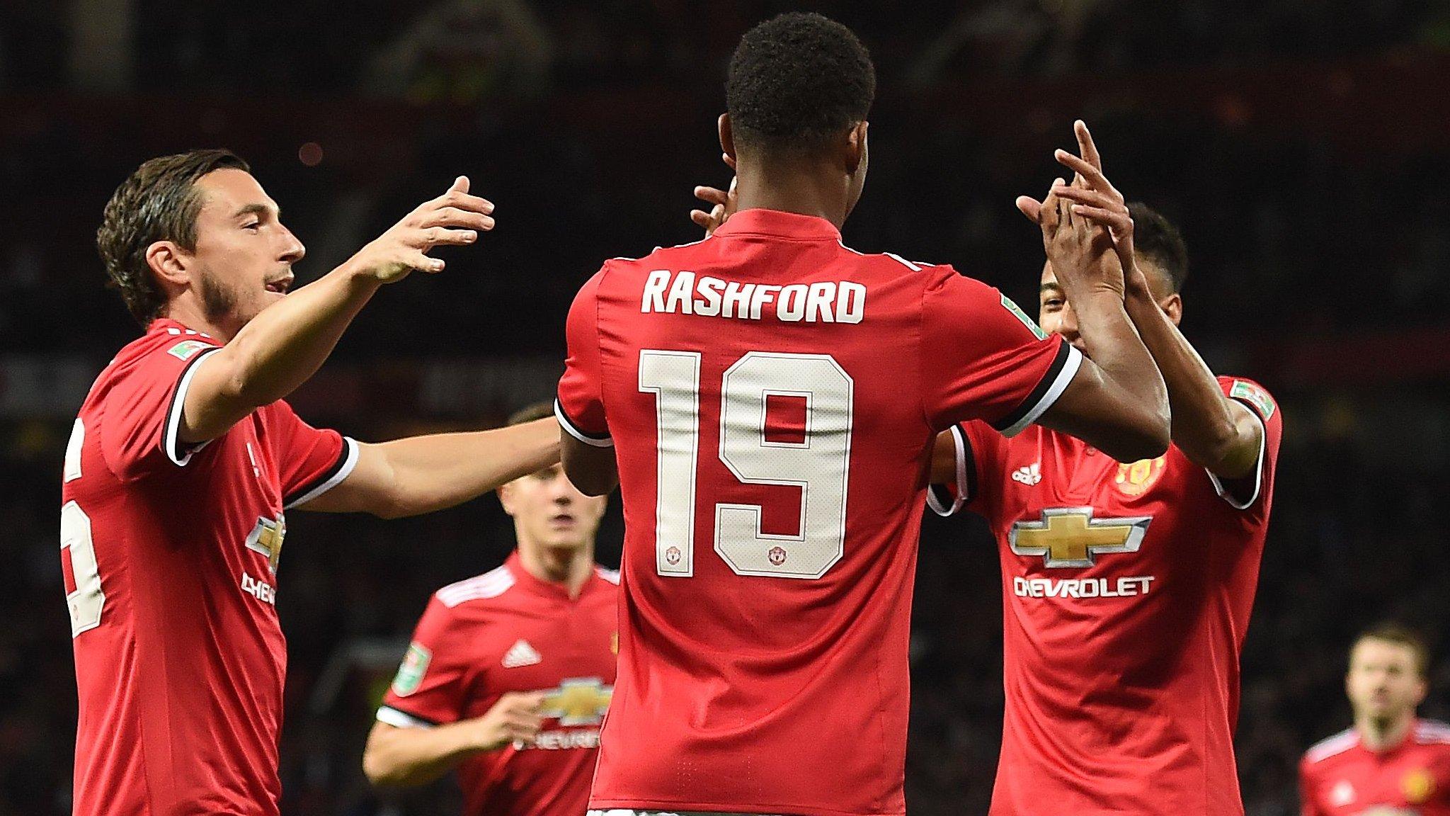 Manchester United's players celebrate scoring against Burton Albion