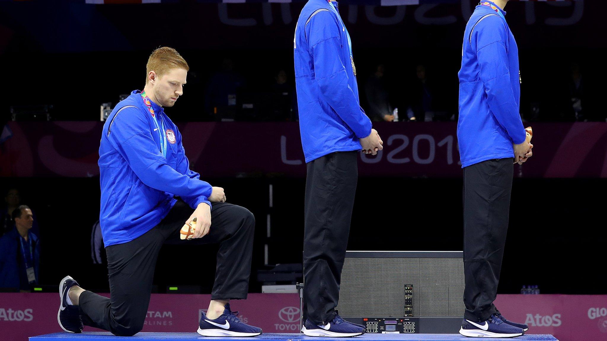 Race Imboden kneels during the national anthem