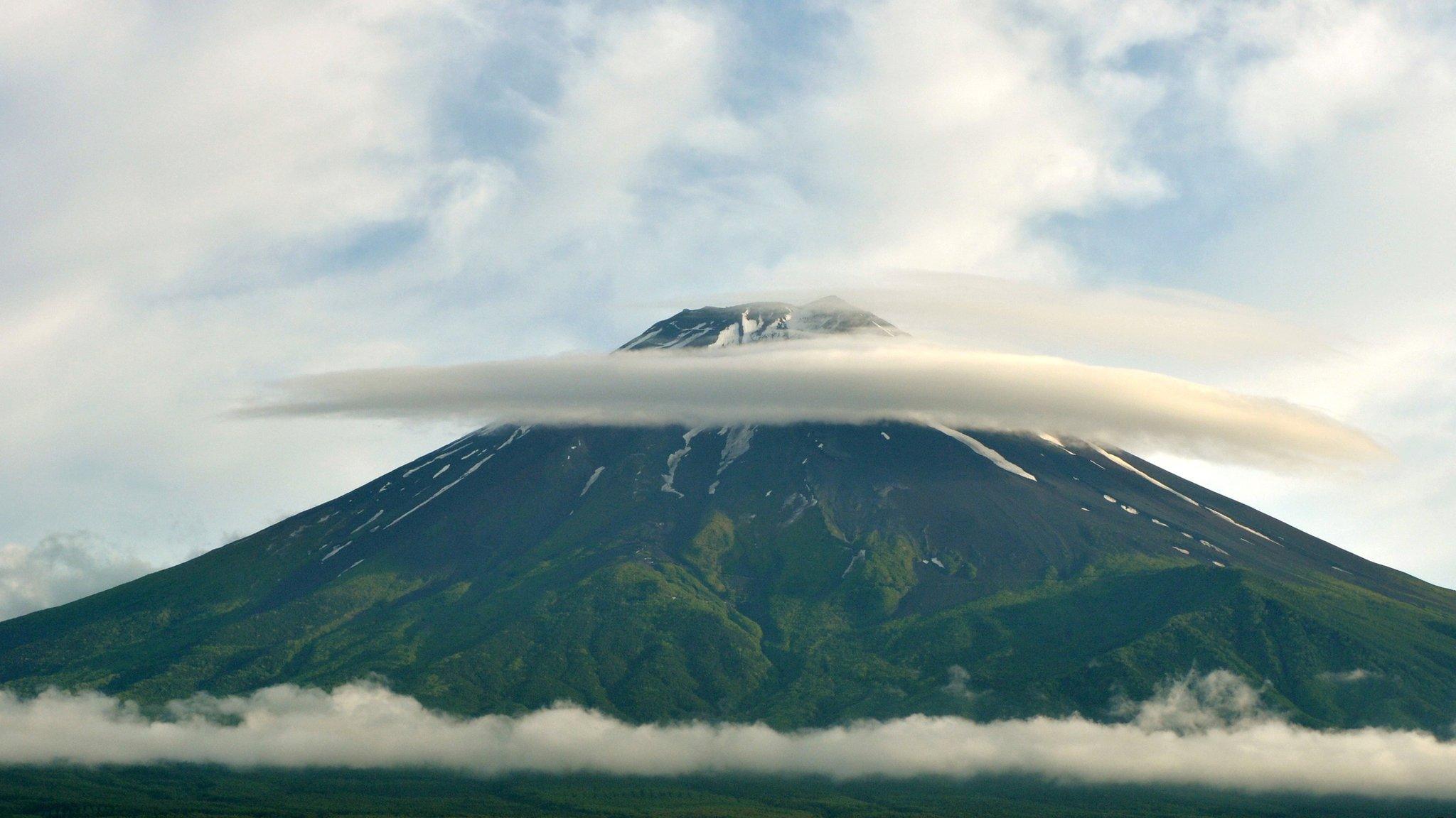 Mount Fuji viewed from a distance, with some cloud near its peak, on 16 June 2013.