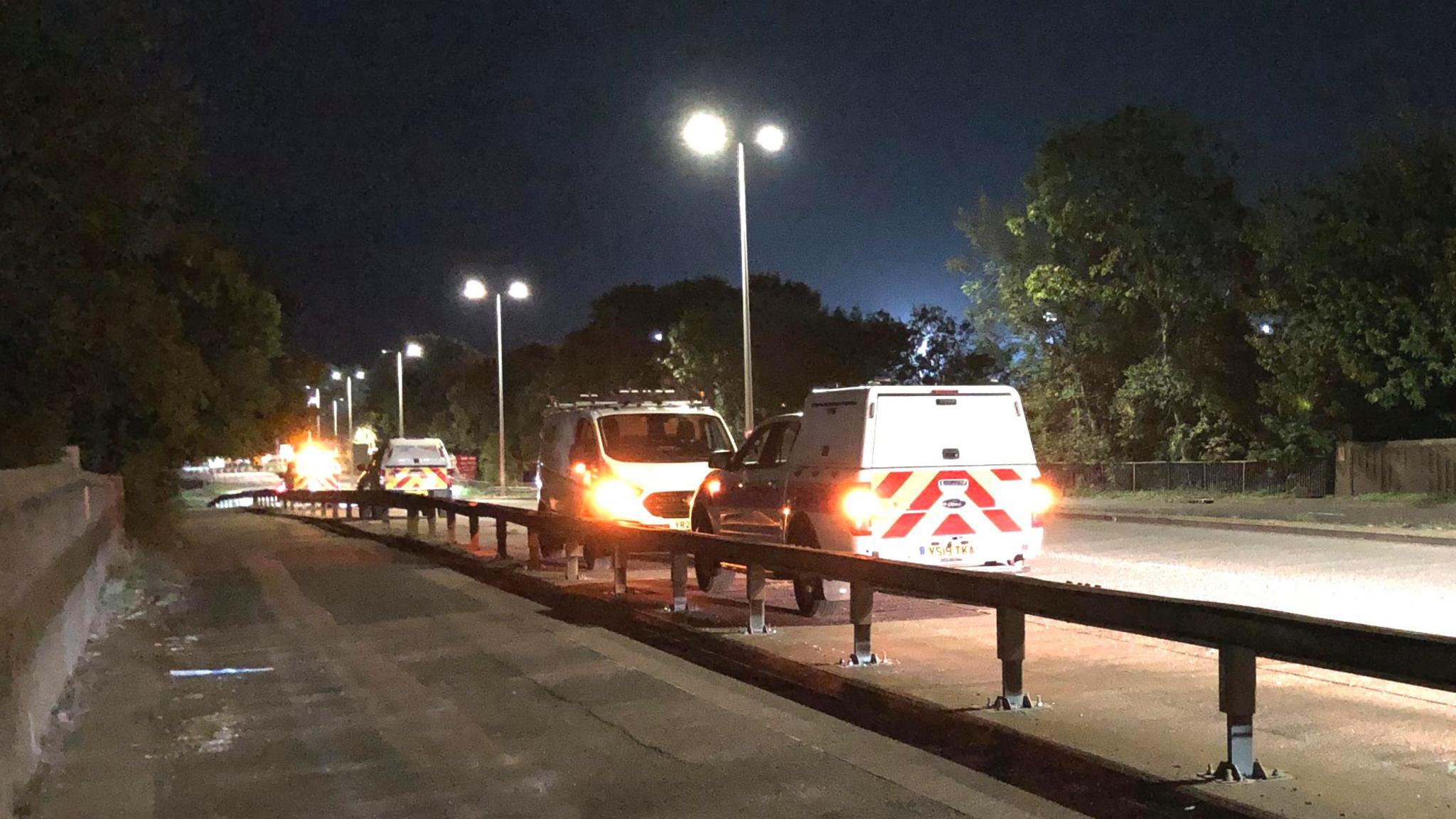 Emergency services vehicles on a bridge over the railway line in Stevenage