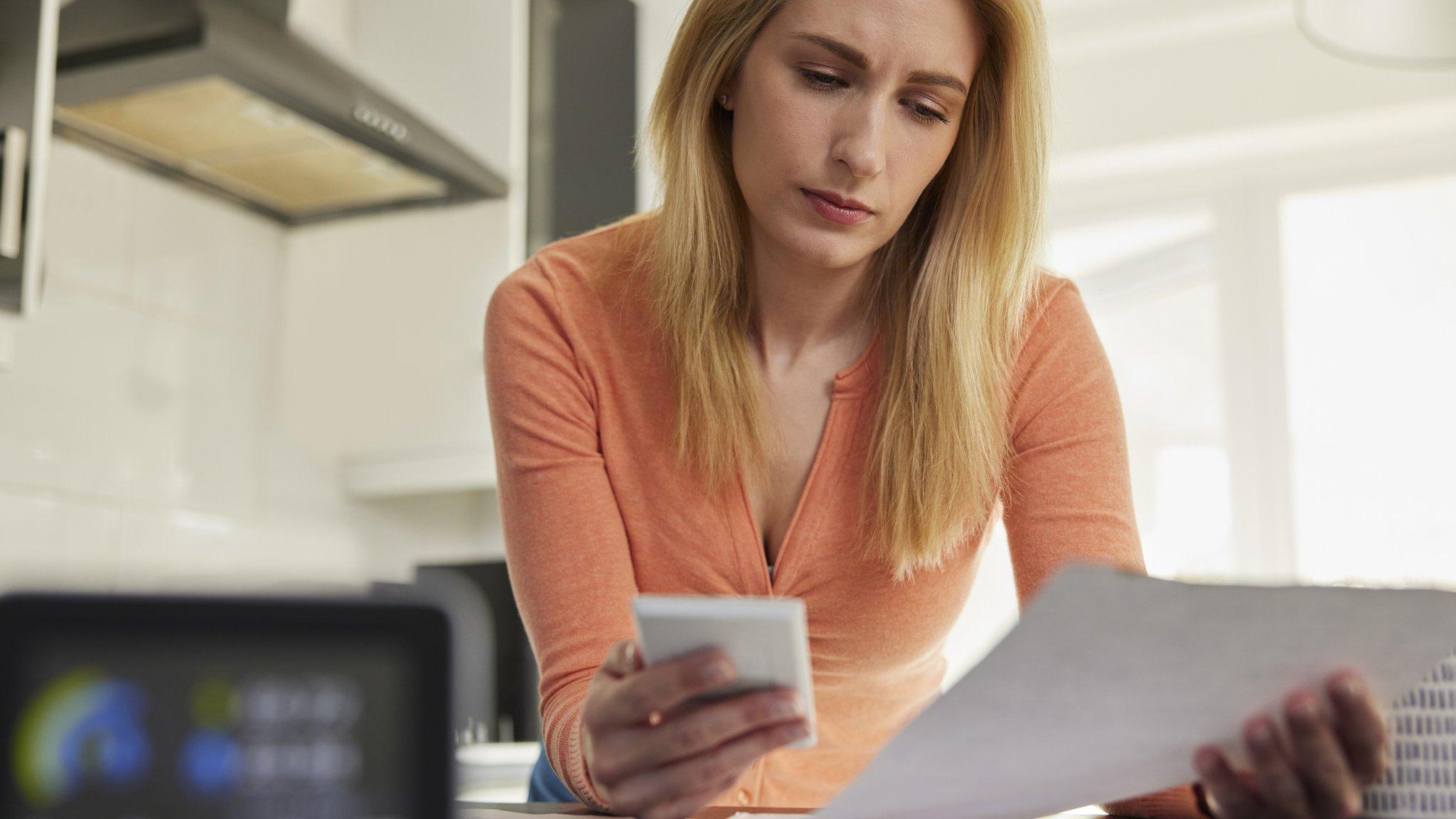 Woman looking at bills